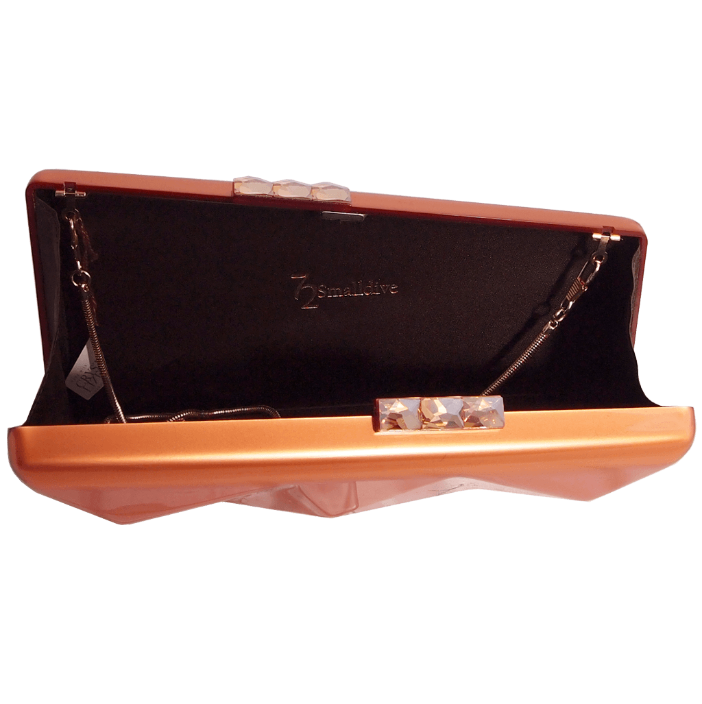 Minaudière clutch in metallic copper with Swarovski Elements clasp, featuring a sleek design and chain strap.