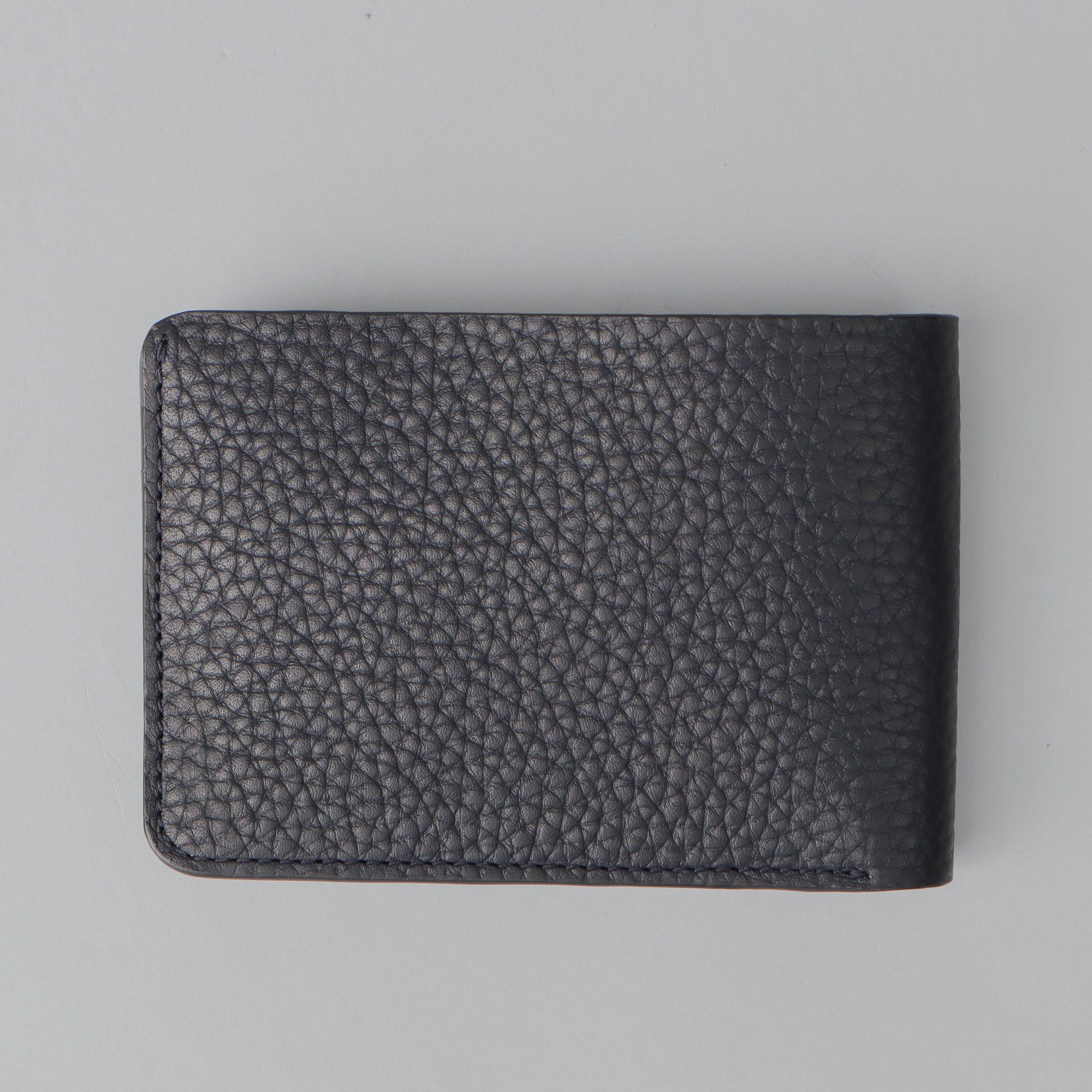 A sleek Minimal Wallet made of premium genuine leather, featuring multiple pockets for cards and cash, displayed on a neutral background.