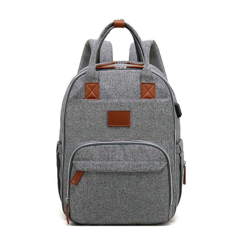 Multifunctional large-capacity mommy bag with USB port, showcasing its stylish design and multiple pockets.