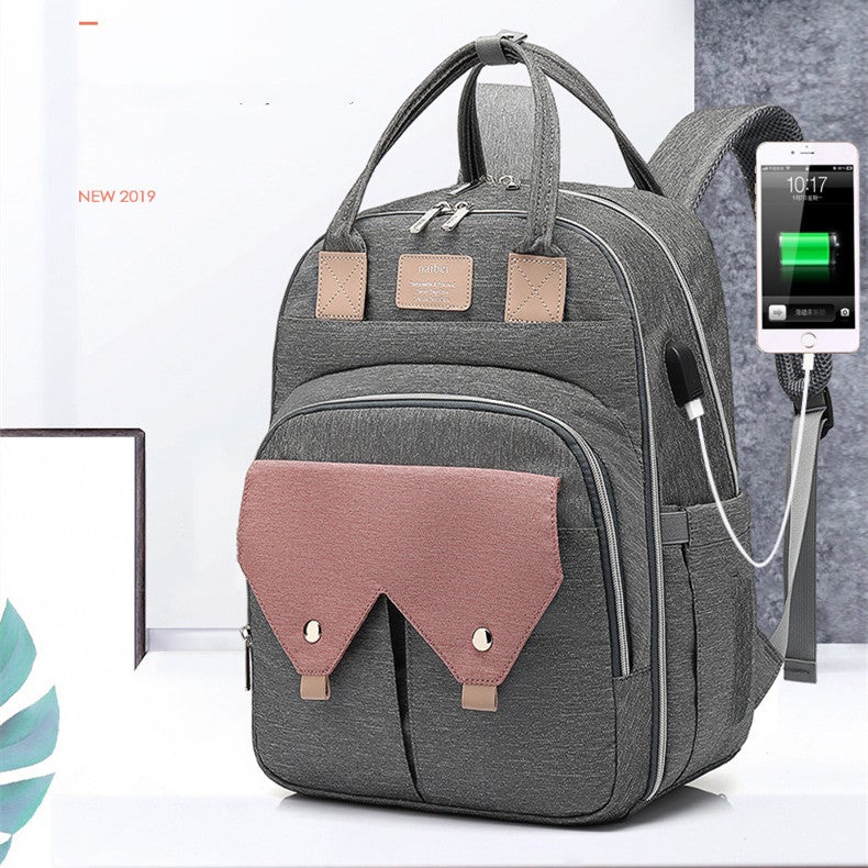 Multifunctional large-capacity mommy bag with USB port, showcasing its stylish design and multiple pockets.