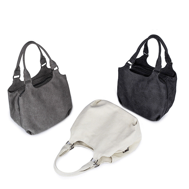 A stylish multifunctional portable canvas bag for moms, featuring multiple compartments and available in black, dark gray, and beige.