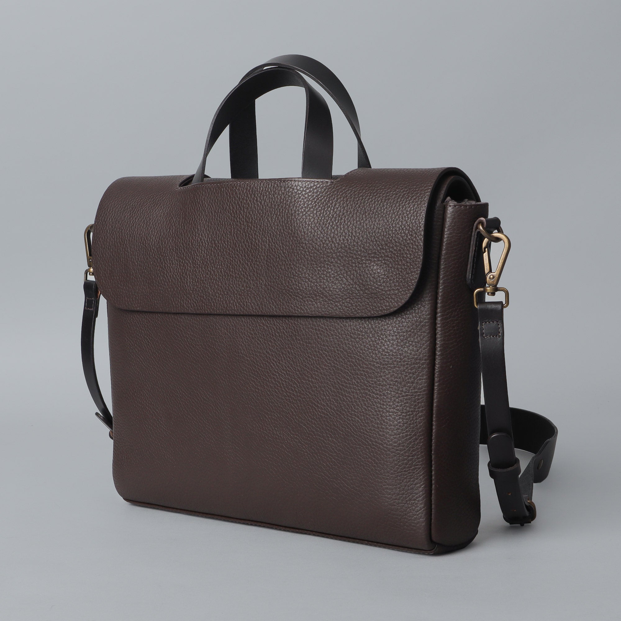Muse Leather Briefcase made from premium full grain leather, featuring multiple pockets and a sleek design.