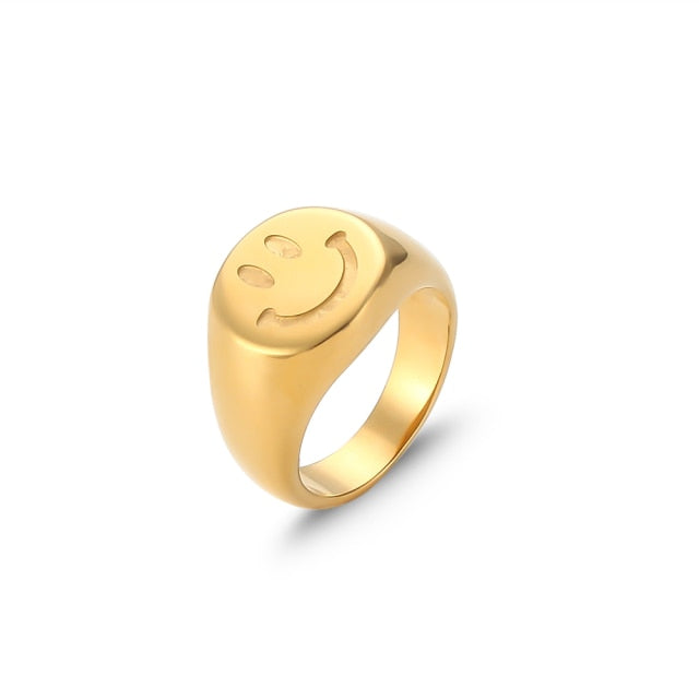 A trendy 18K gold plated stainless steel ring featuring a playful smiley face design, perfect for women.