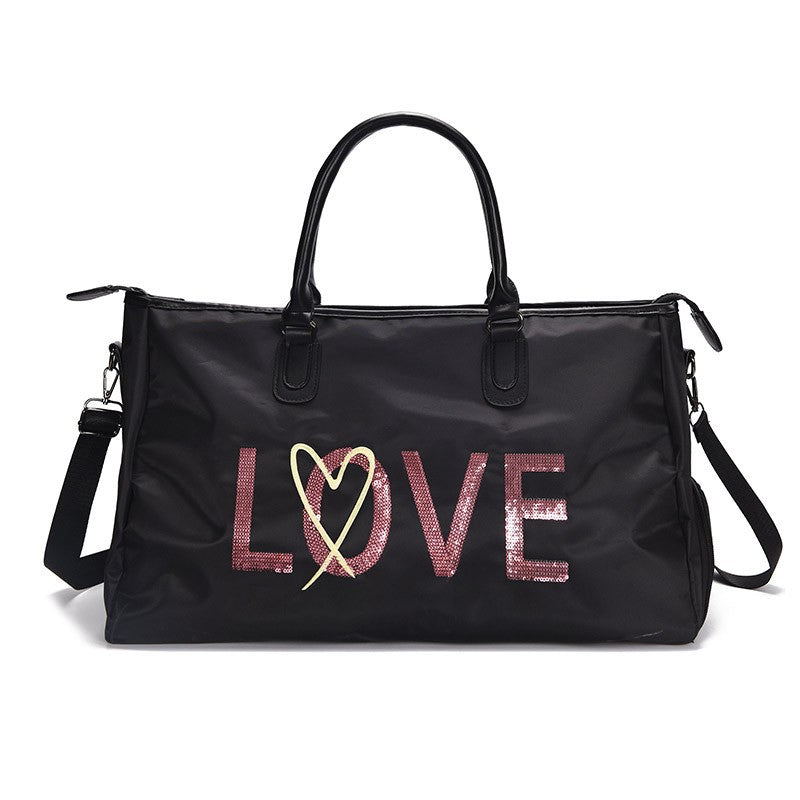 One-shoulder large capacity fitness travel bag with a stylish letter pattern, featuring a soft handle and adjustable shoulder strap.
