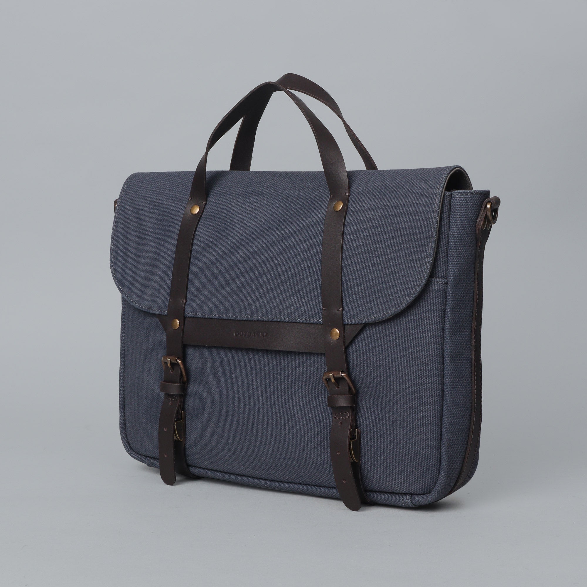 Oslo Canvas Briefcase featuring durable cotton canvas, leather straps, and multiple pockets for organization, ideal for laptops up to 13 inches.
