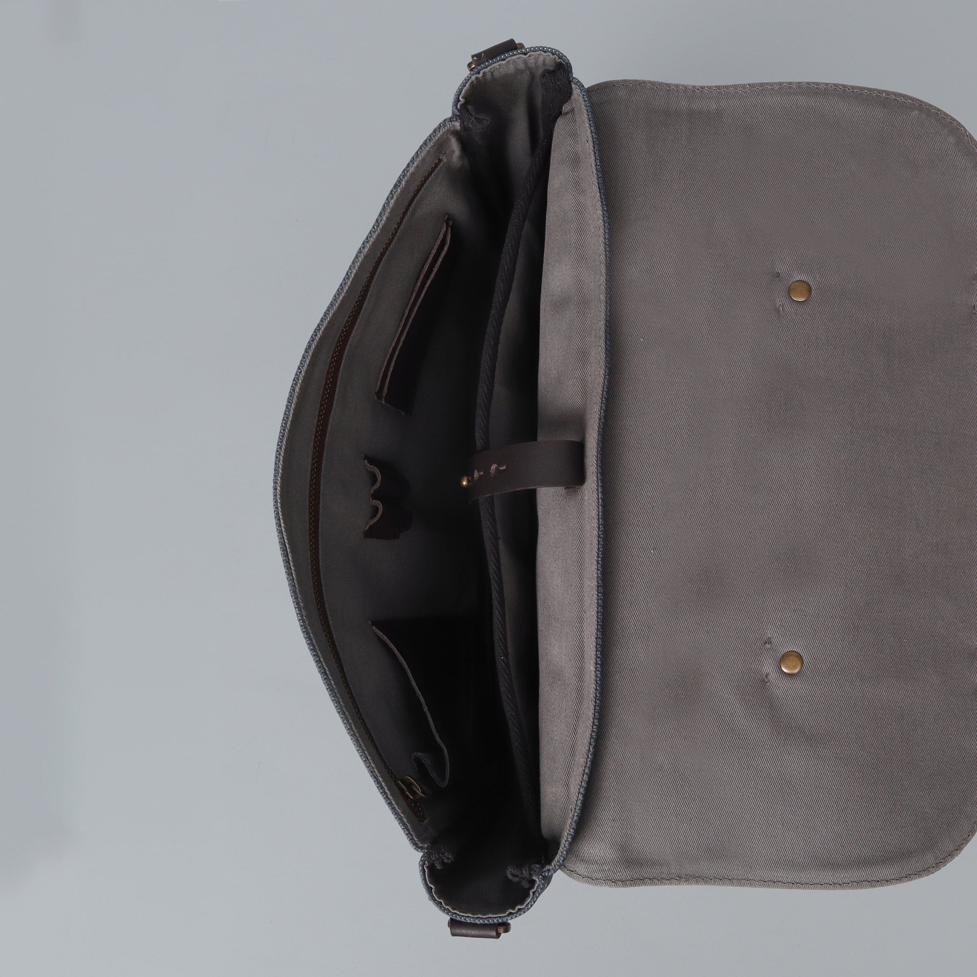 Oslo Canvas Briefcase featuring durable cotton canvas, leather straps, and multiple pockets for organization, ideal for laptops up to 13 inches.