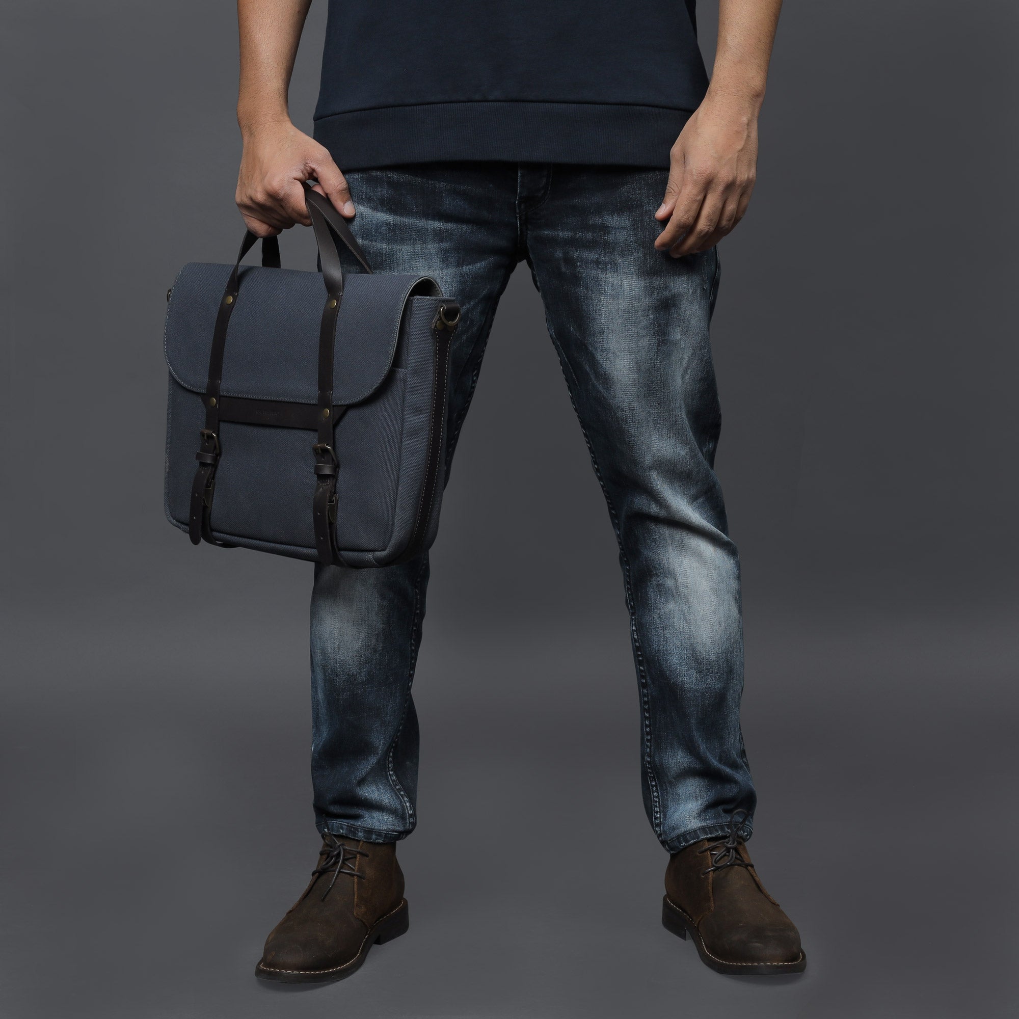 Oslo Canvas Briefcase featuring durable cotton canvas, leather straps, and multiple pockets for organization, ideal for laptops up to 13 inches.