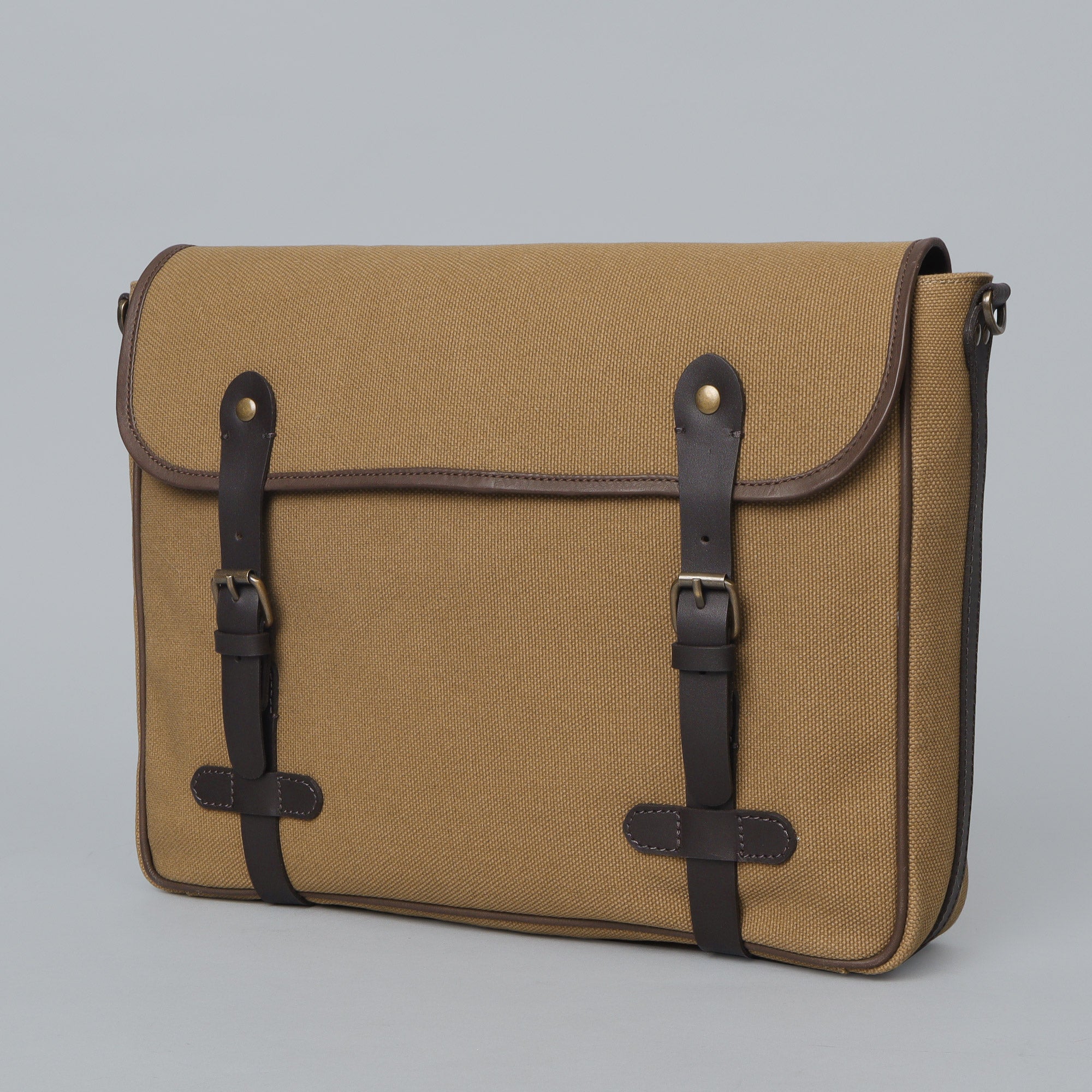 Oslo Canvas Messenger Bag featuring a separate laptop compartment, genuine leather strap, and durable cotton canvas material.