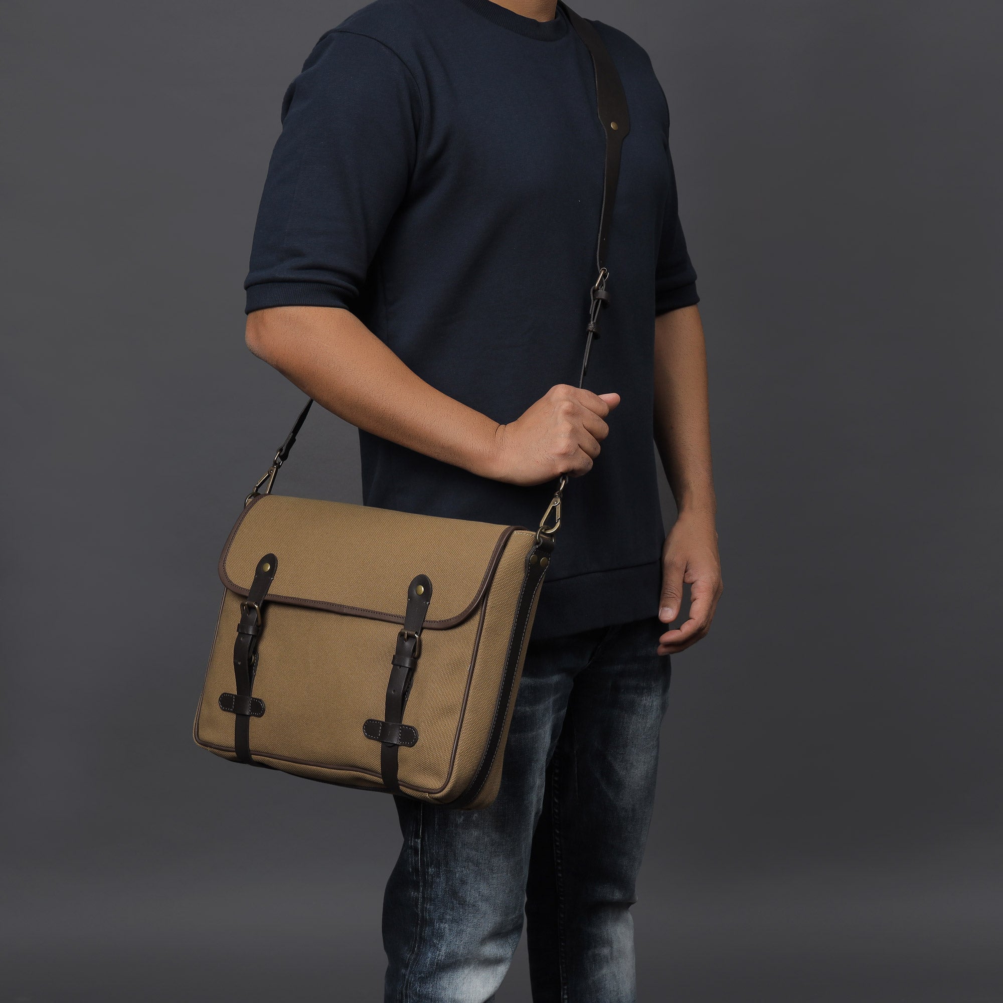 Oslo Canvas Messenger Bag featuring a separate laptop compartment, genuine leather strap, and durable cotton canvas material.