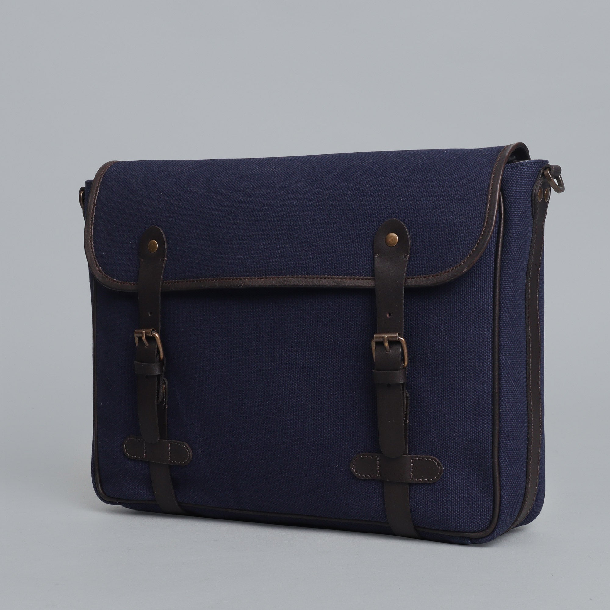 Oslo Canvas Messenger Bag featuring a separate laptop compartment, genuine leather strap, and durable cotton canvas material.
