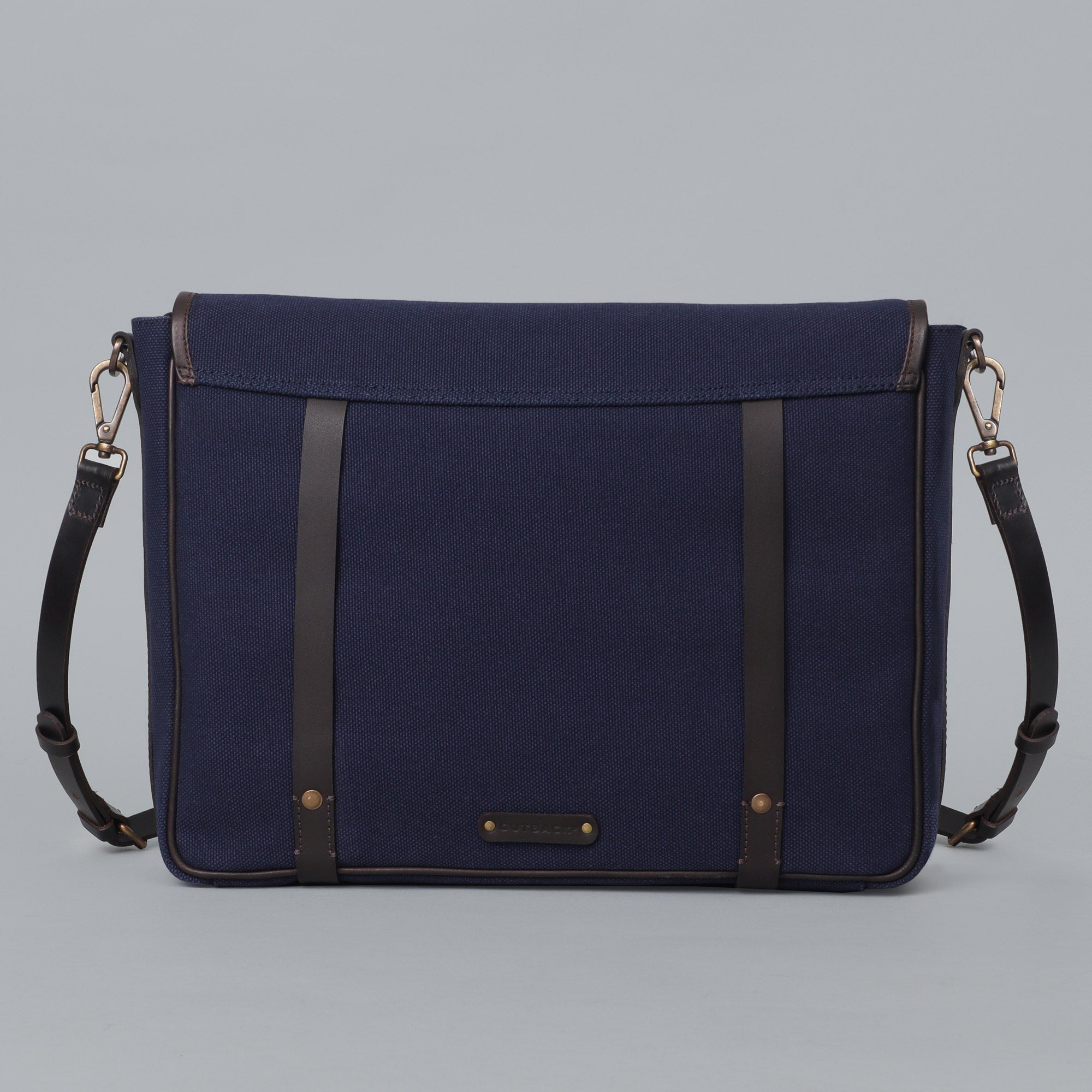 Oslo Canvas Messenger Bag featuring a separate laptop compartment, genuine leather strap, and durable cotton canvas material.