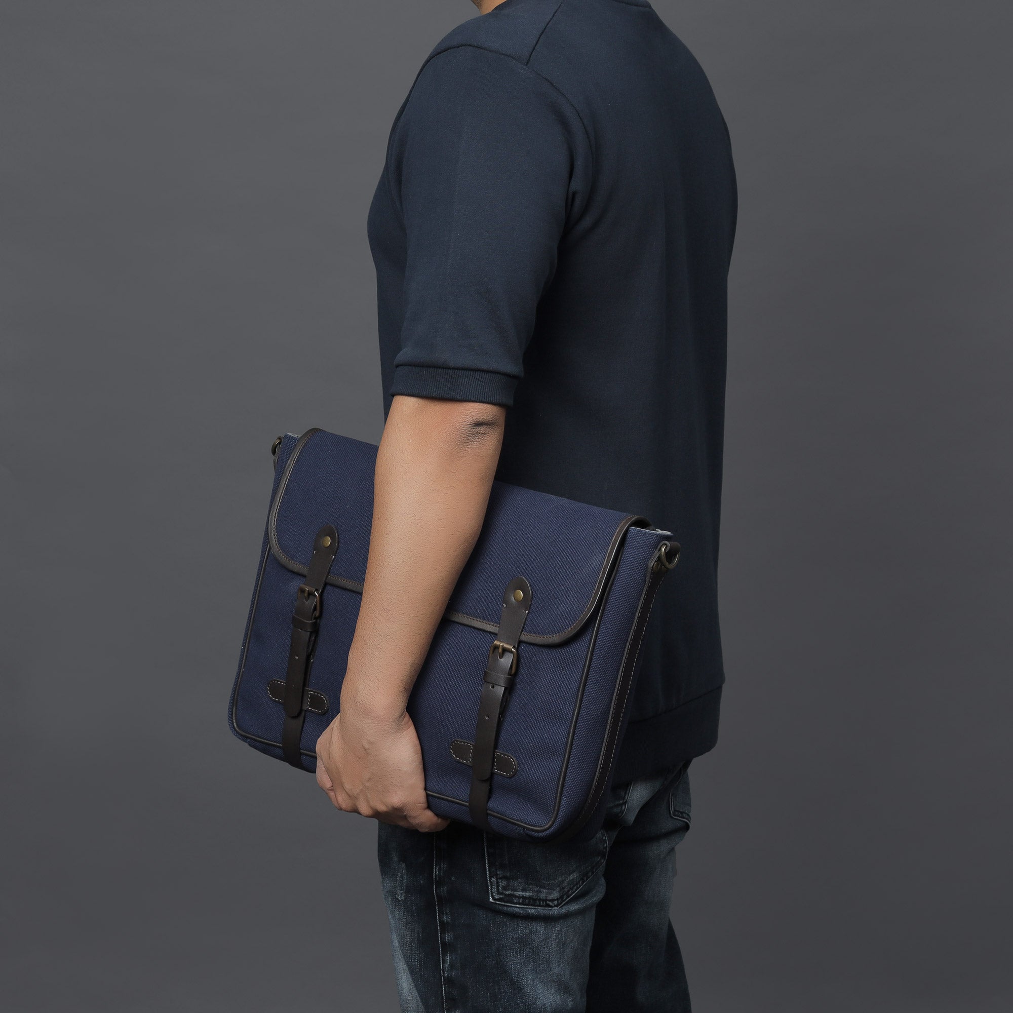 Oslo Canvas Messenger Bag featuring a separate laptop compartment, genuine leather strap, and durable cotton canvas material.