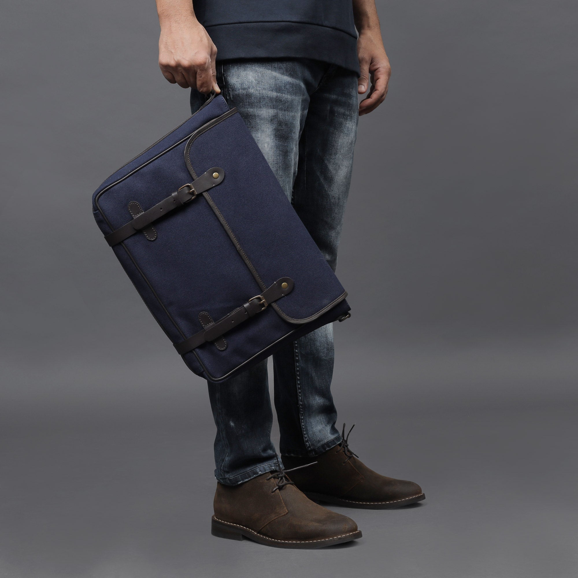 Oslo Canvas Messenger Bag featuring a separate laptop compartment, genuine leather strap, and durable cotton canvas material.