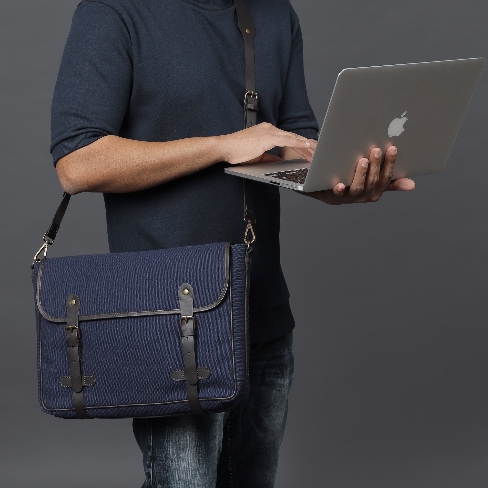 Oslo Canvas Messenger Bag featuring a separate laptop compartment, genuine leather strap, and durable cotton canvas material.