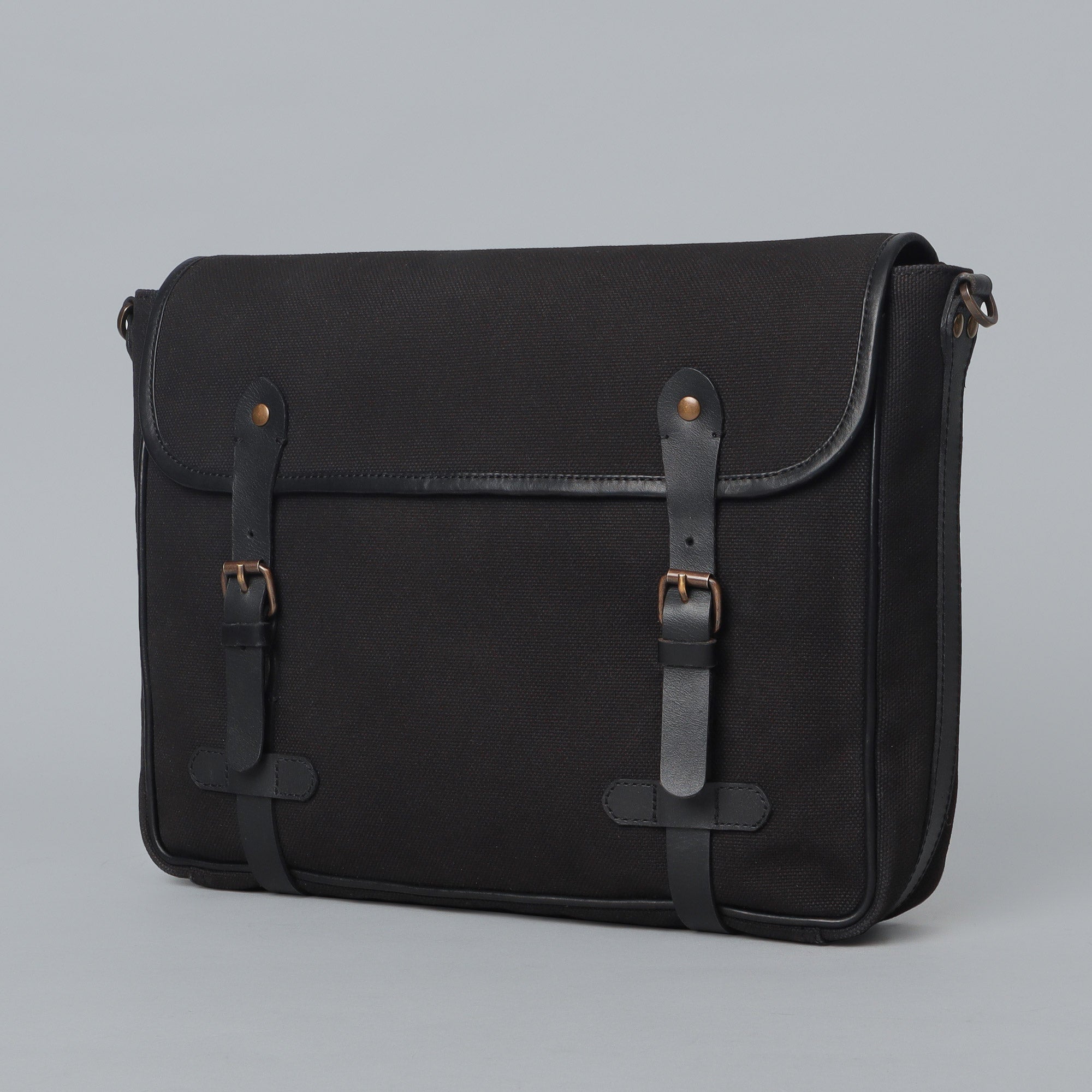 Oslo Canvas Messenger Bag featuring a separate laptop compartment, genuine leather strap, and durable cotton canvas material.