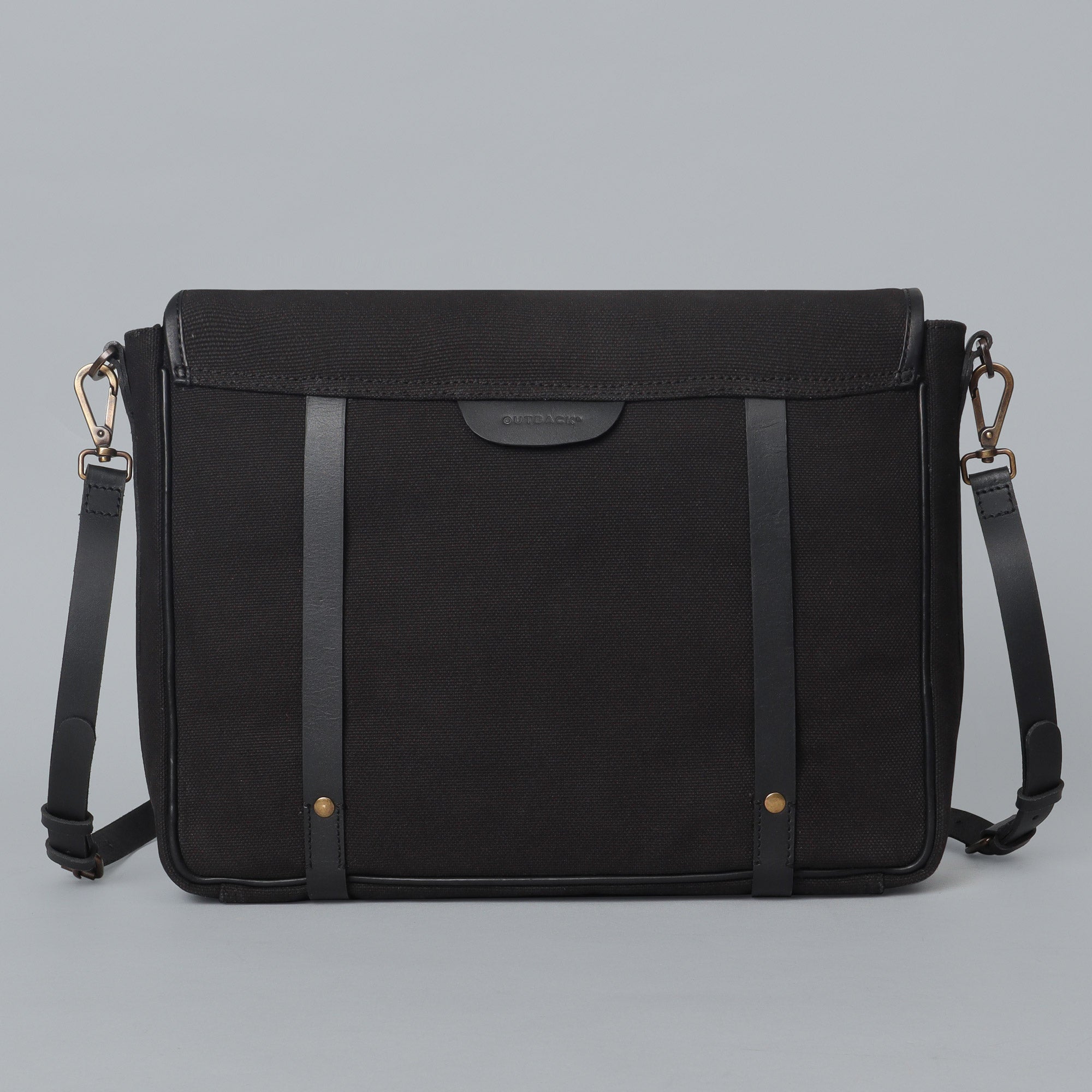 Oslo Canvas Messenger Bag featuring a separate laptop compartment, genuine leather strap, and durable cotton canvas material.