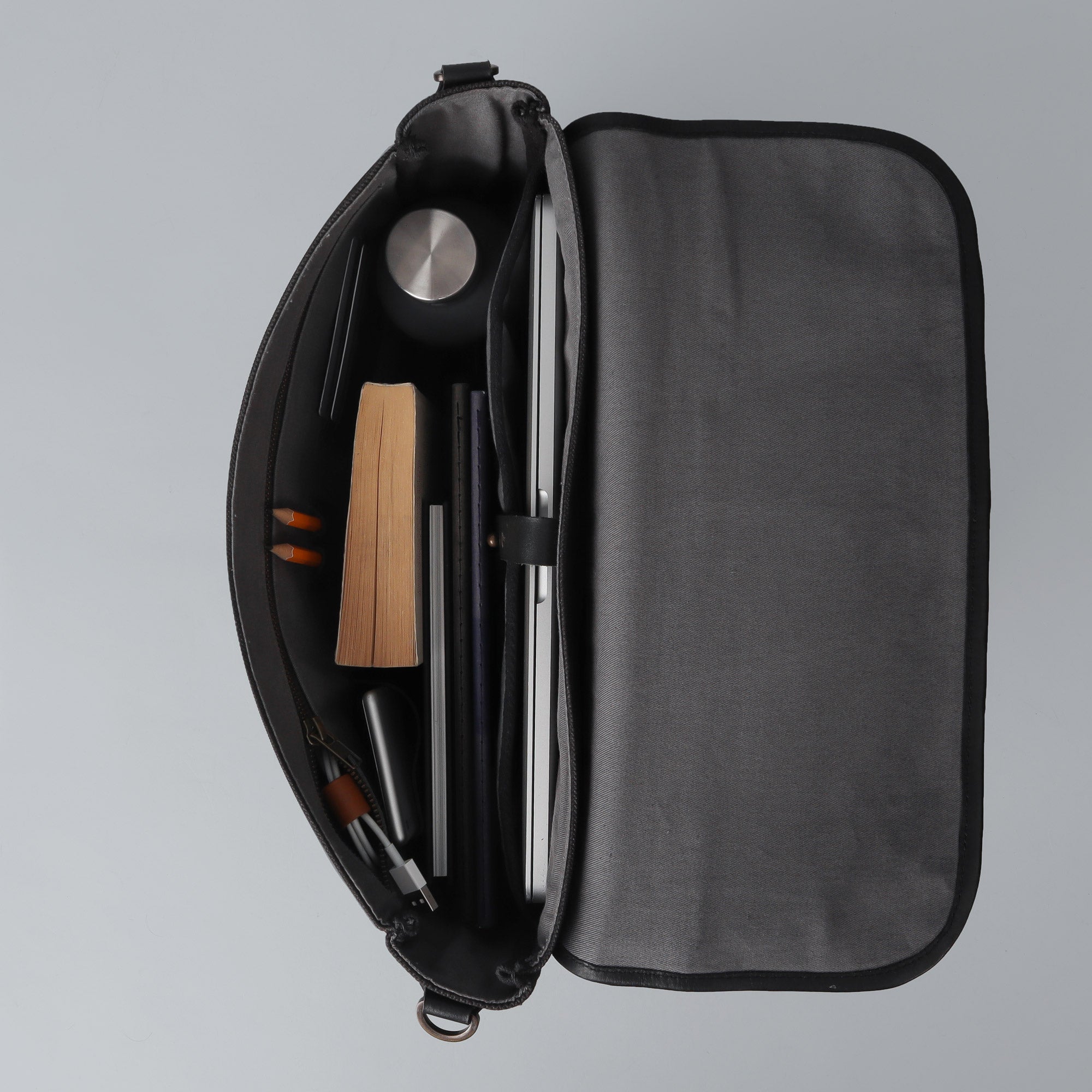 Oslo Canvas Messenger Bag featuring a separate laptop compartment, genuine leather strap, and durable cotton canvas material.
