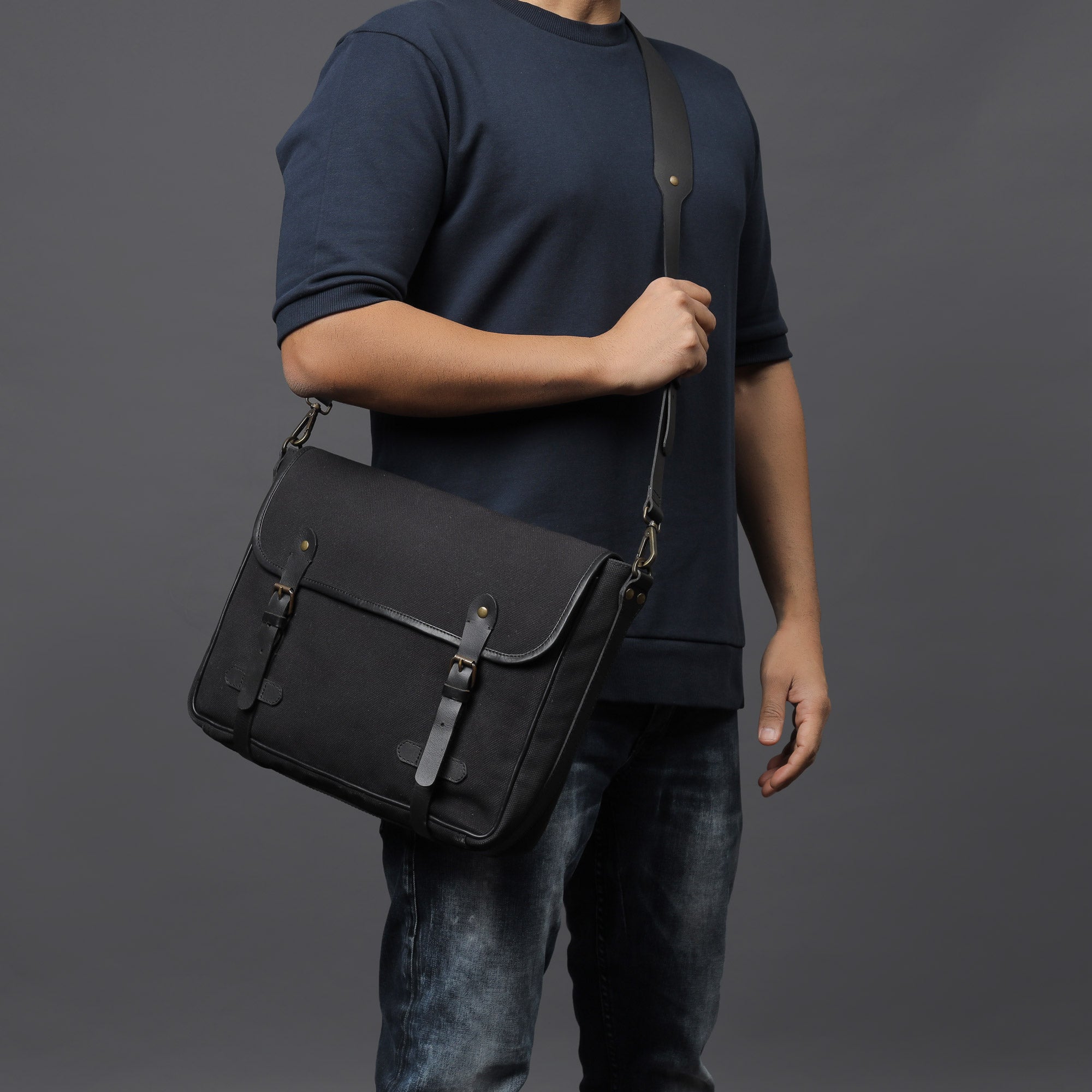 Oslo Canvas Messenger Bag featuring a separate laptop compartment, genuine leather strap, and durable cotton canvas material.