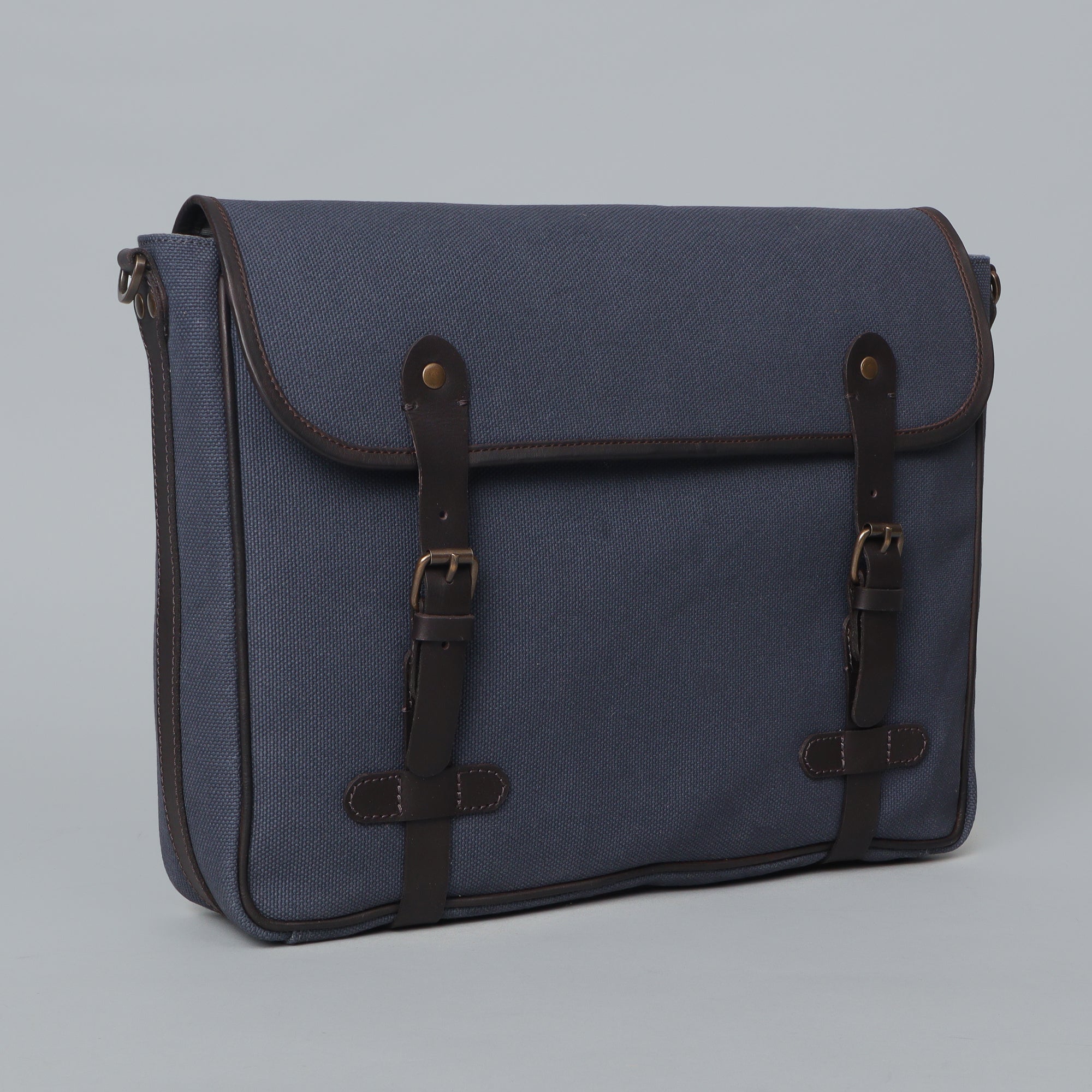 Oslo Canvas Messenger Bag featuring a separate laptop compartment, zipper pocket, and durable cotton canvas material.