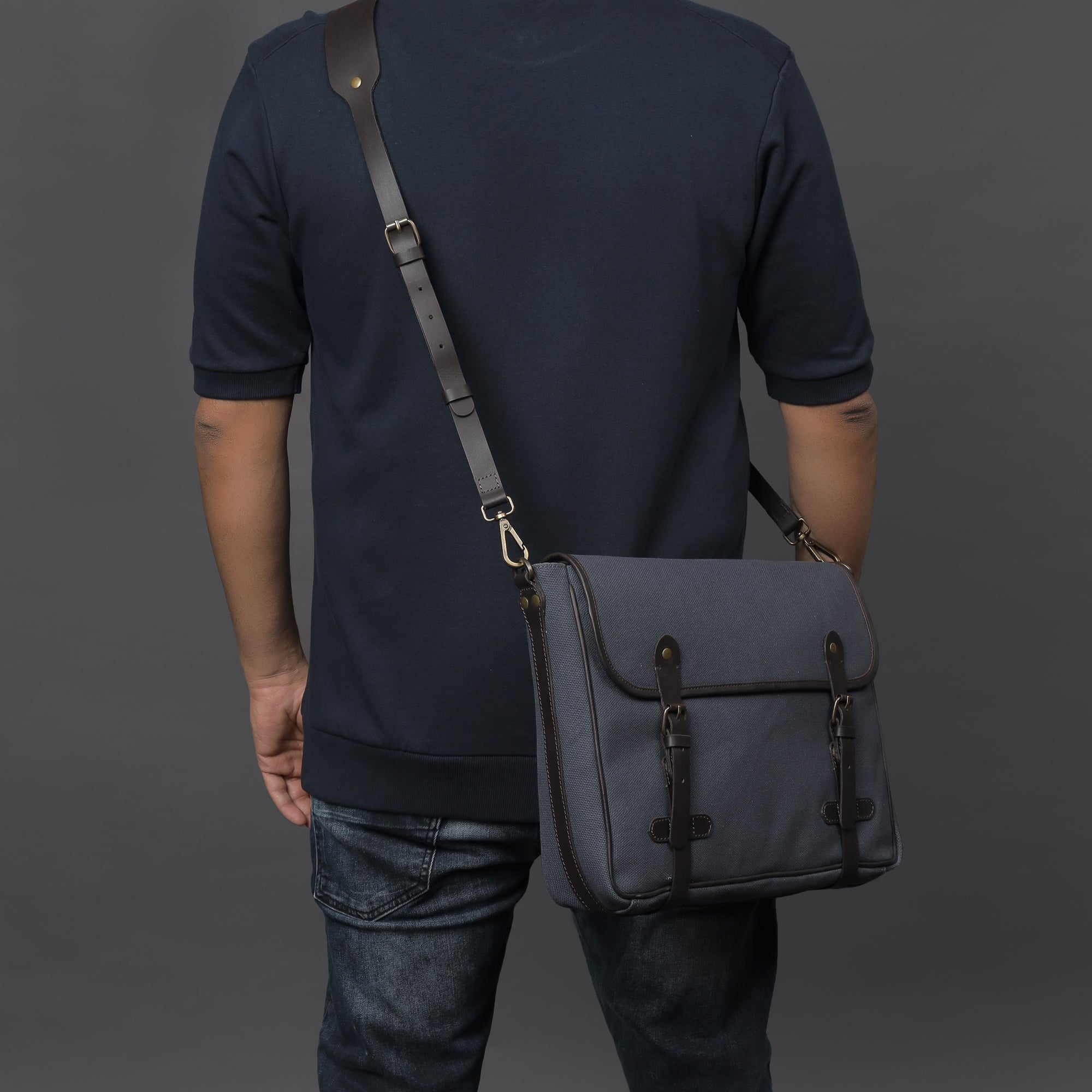 Oslo Canvas Messenger Bag featuring a separate laptop compartment, zipper pocket, and durable cotton canvas material.