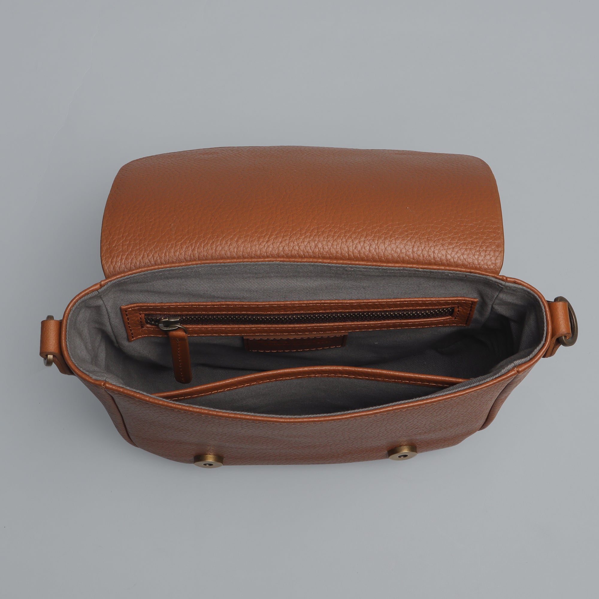 Oslo Crossbody Bag made from premium leather with spacious compartments and antique brass hardware, showcasing its elegant design.