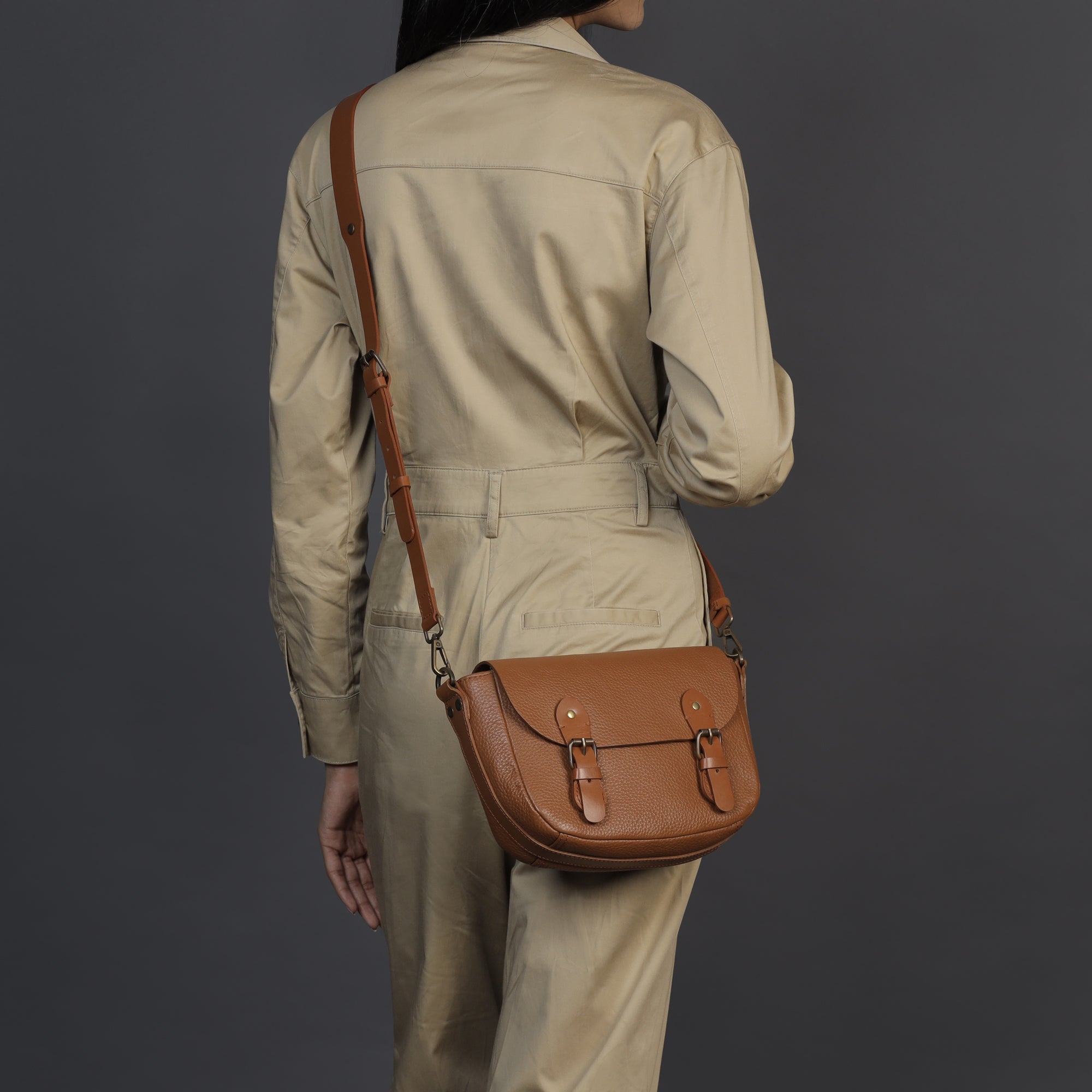 Oslo Crossbody Bag made from premium leather with spacious compartments and antique brass hardware, showcasing its elegant design.