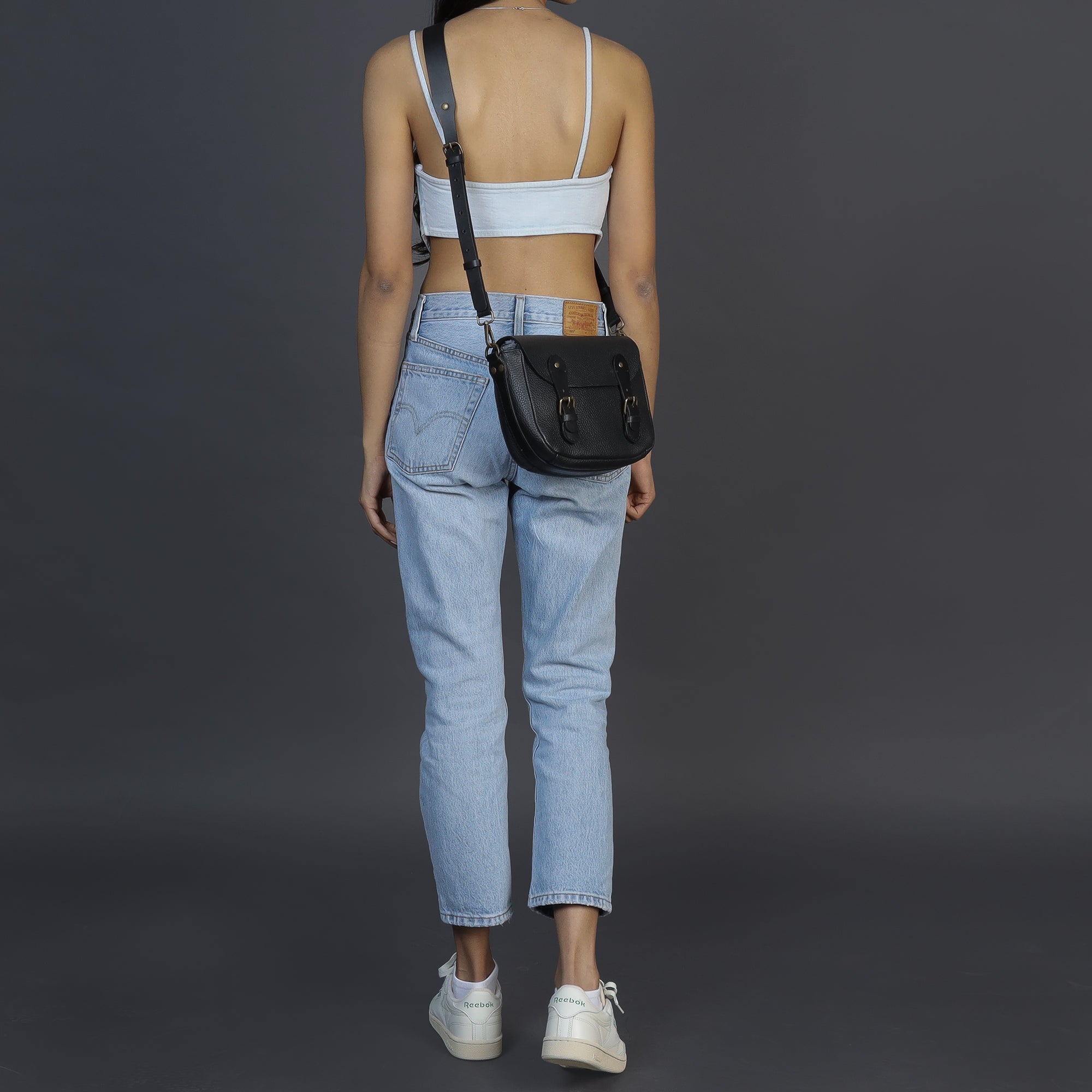 Oslo Crossbody Bag made from premium leather with spacious compartments and antique brass hardware, showcasing its elegant design.