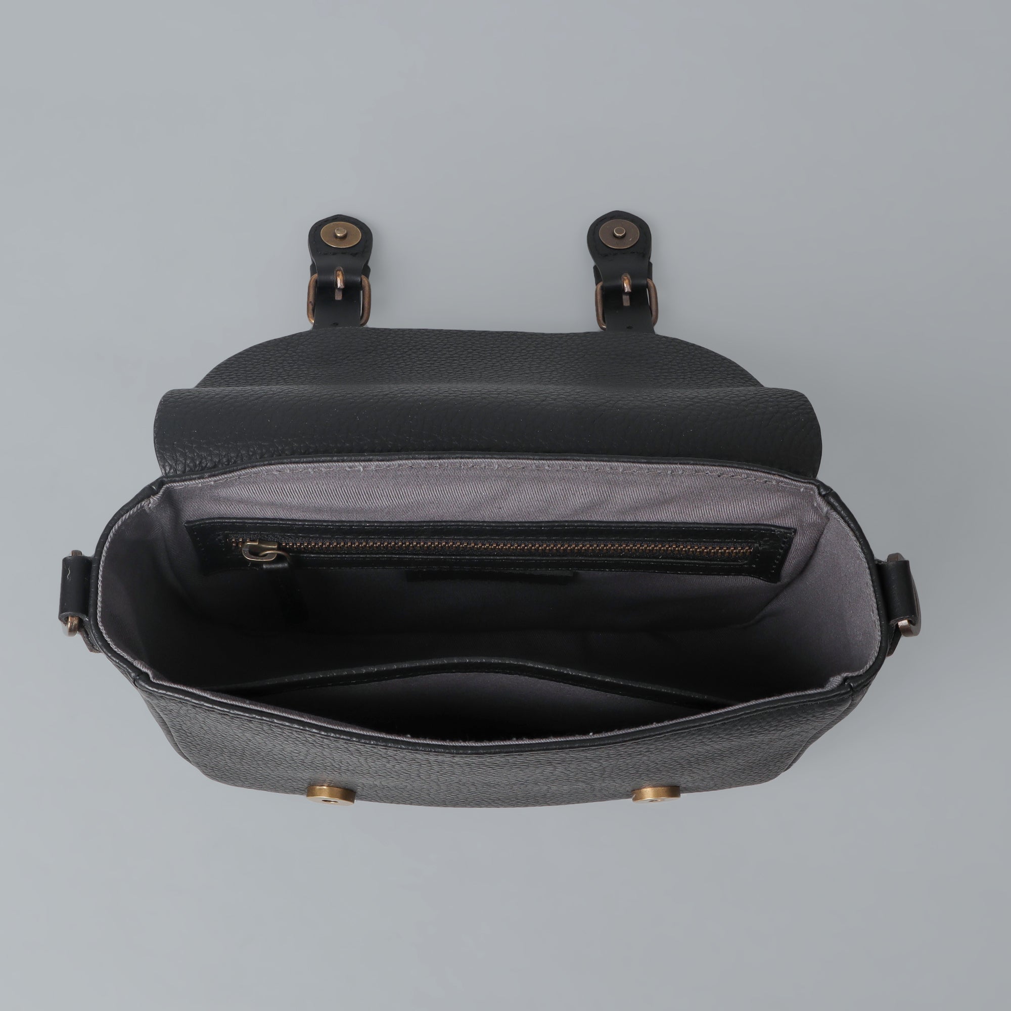 Oslo Crossbody Bag made from premium leather with spacious compartments and antique brass hardware, showcasing its elegant design.