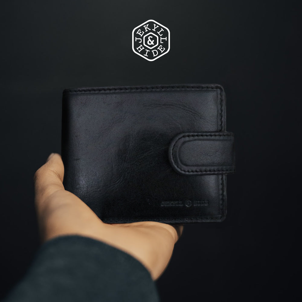 Oxford Bifold Wallet in black leather with coin and tab closure, showcasing its sleek design and compact size.