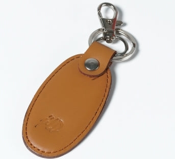 Pack of 3 real leather key chains in black, blue, and camel brown with silver key rings and JILD logo embossing.