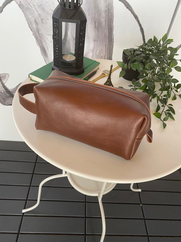 Partenon Genuine Leather Dopp Kit in various colors, showcasing its elegant design and zipper feature.