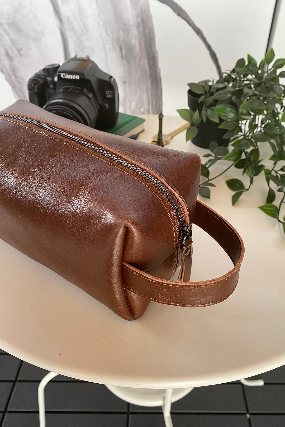 Partenon Genuine Leather Dopp Kit in various colors, showcasing its elegant design and zipper feature.