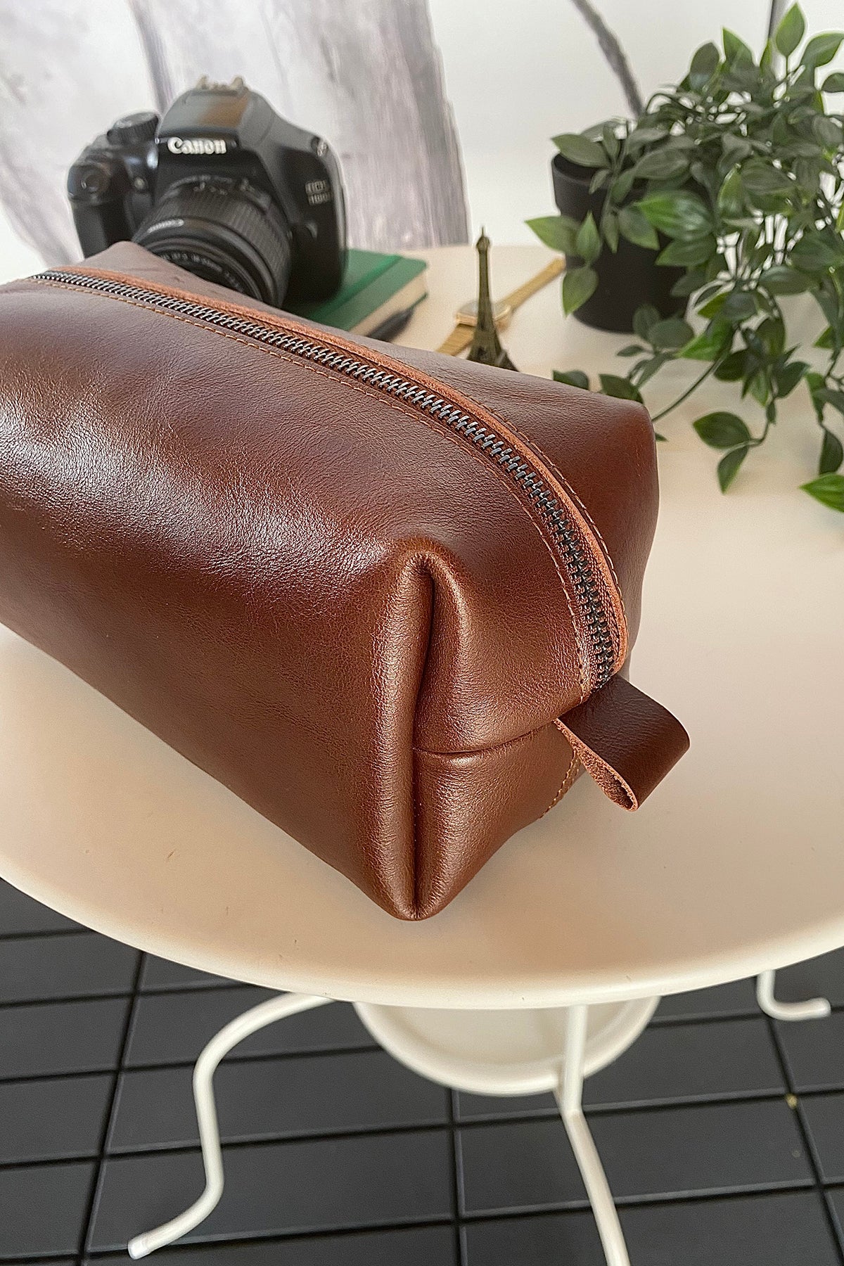 Partenon Genuine Leather Dopp Kit in various colors, showcasing its elegant design and zipper feature.