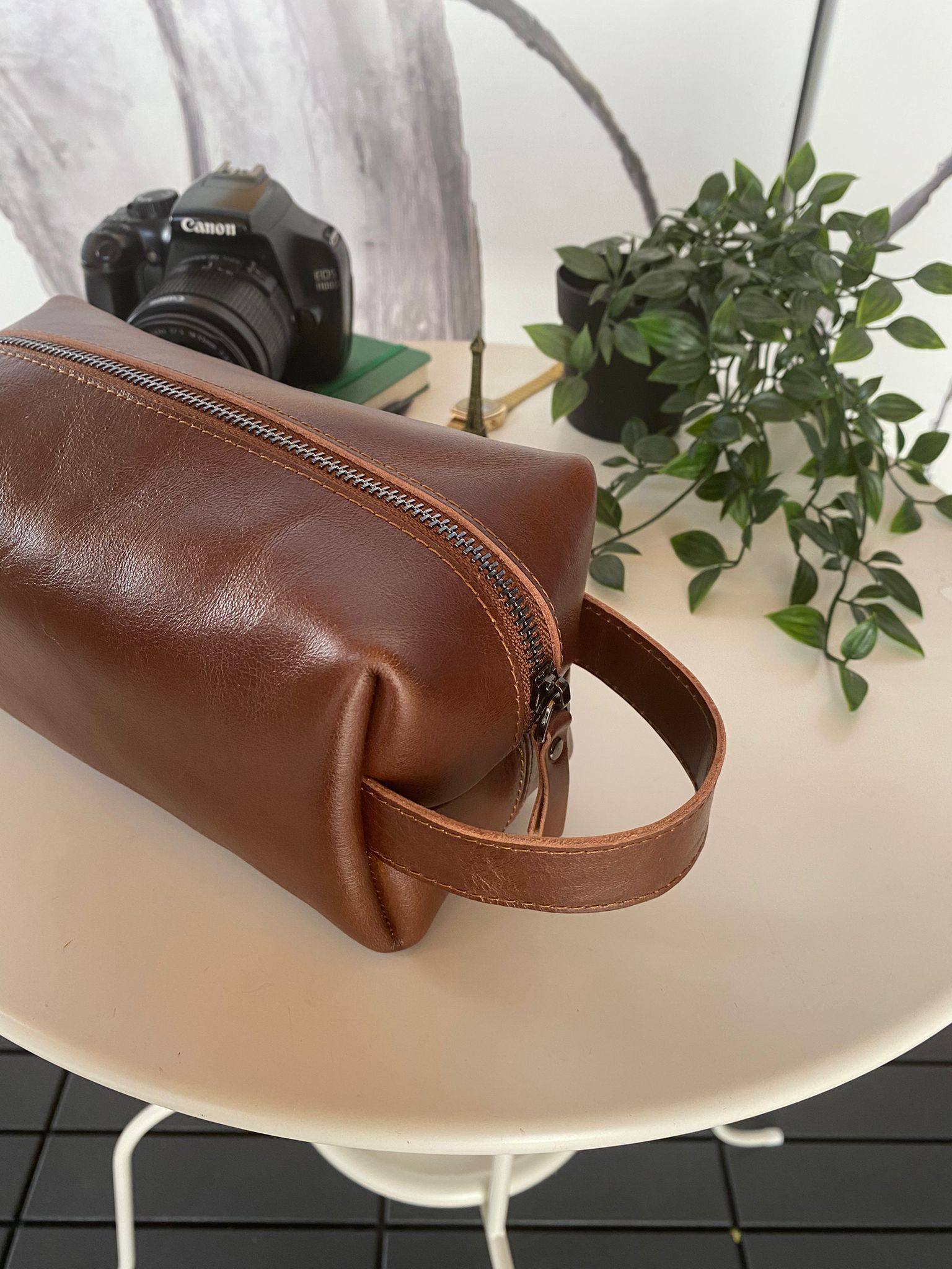 Partenon Genuine Leather Dopp Kit in various colors, showcasing its elegant design and zipper feature.