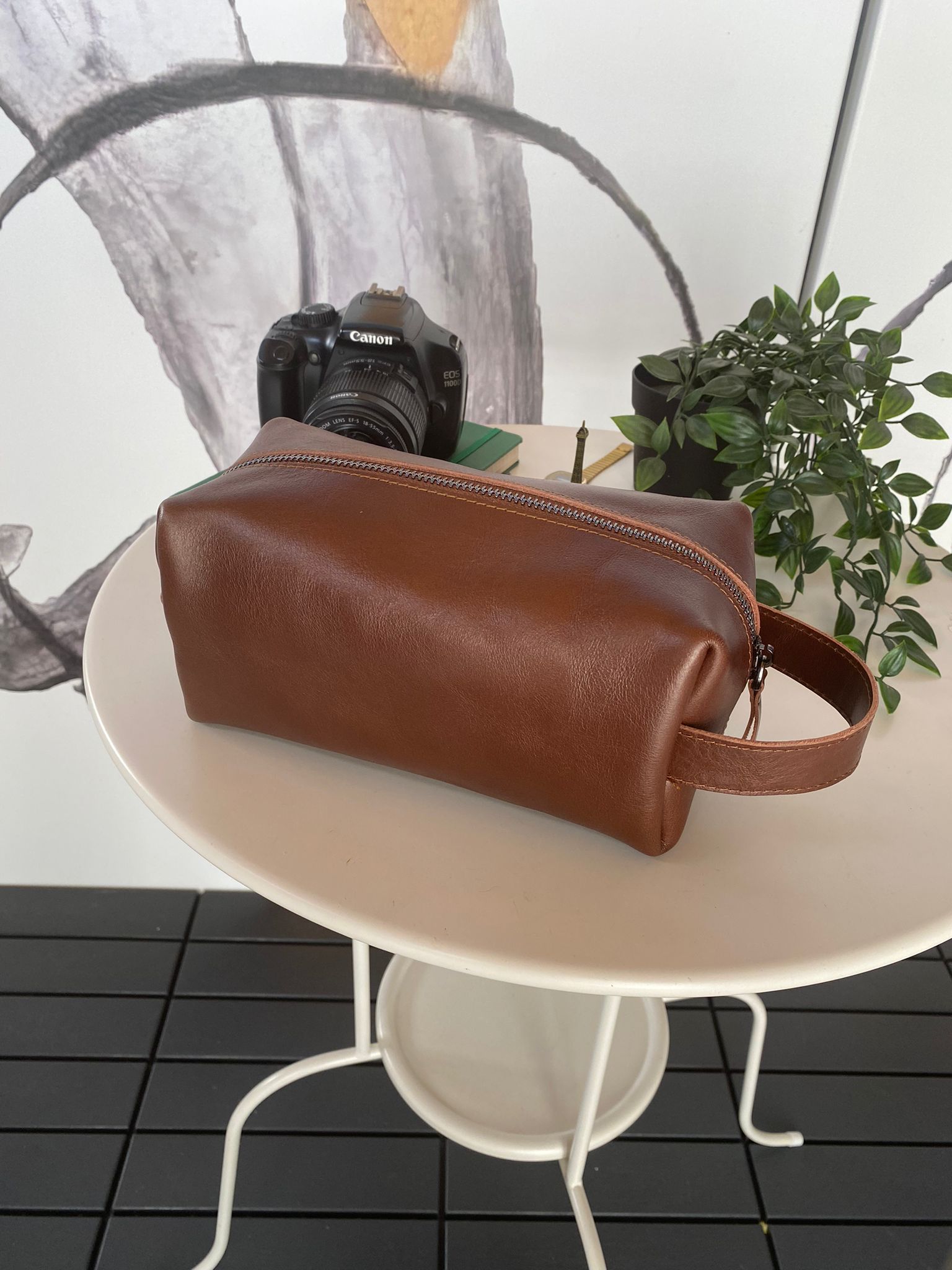 Partenon Genuine Leather Dopp Kit in various colors, showcasing its elegant design and zipper feature.