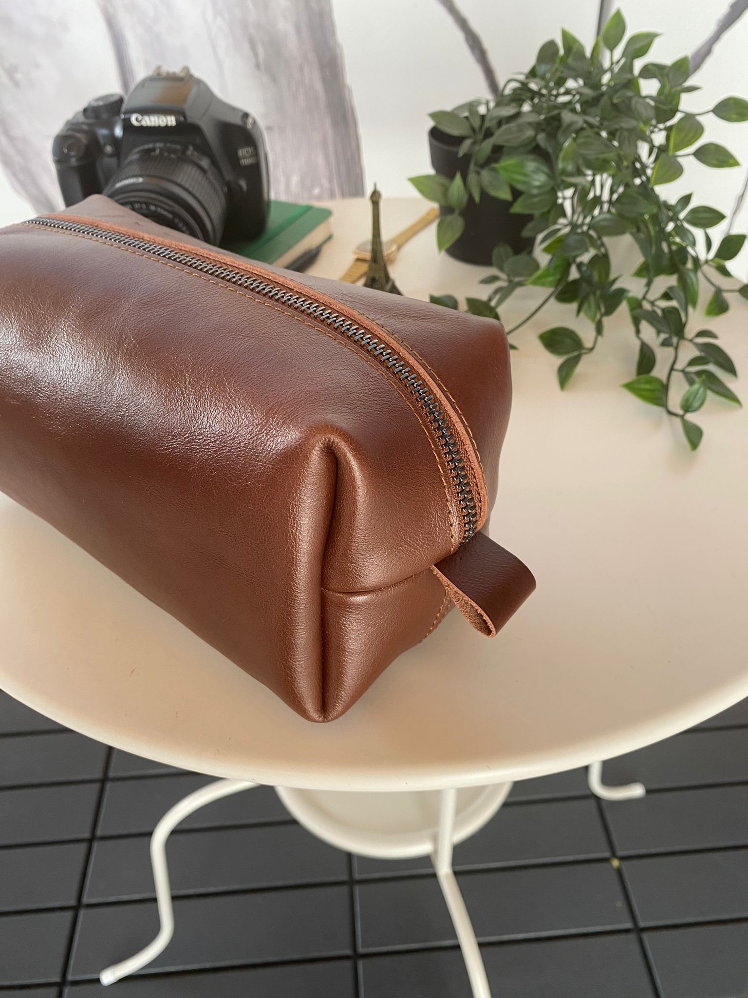 Partenon Genuine Leather Dopp Kit in various colors, showcasing its elegant design and zipper feature.
