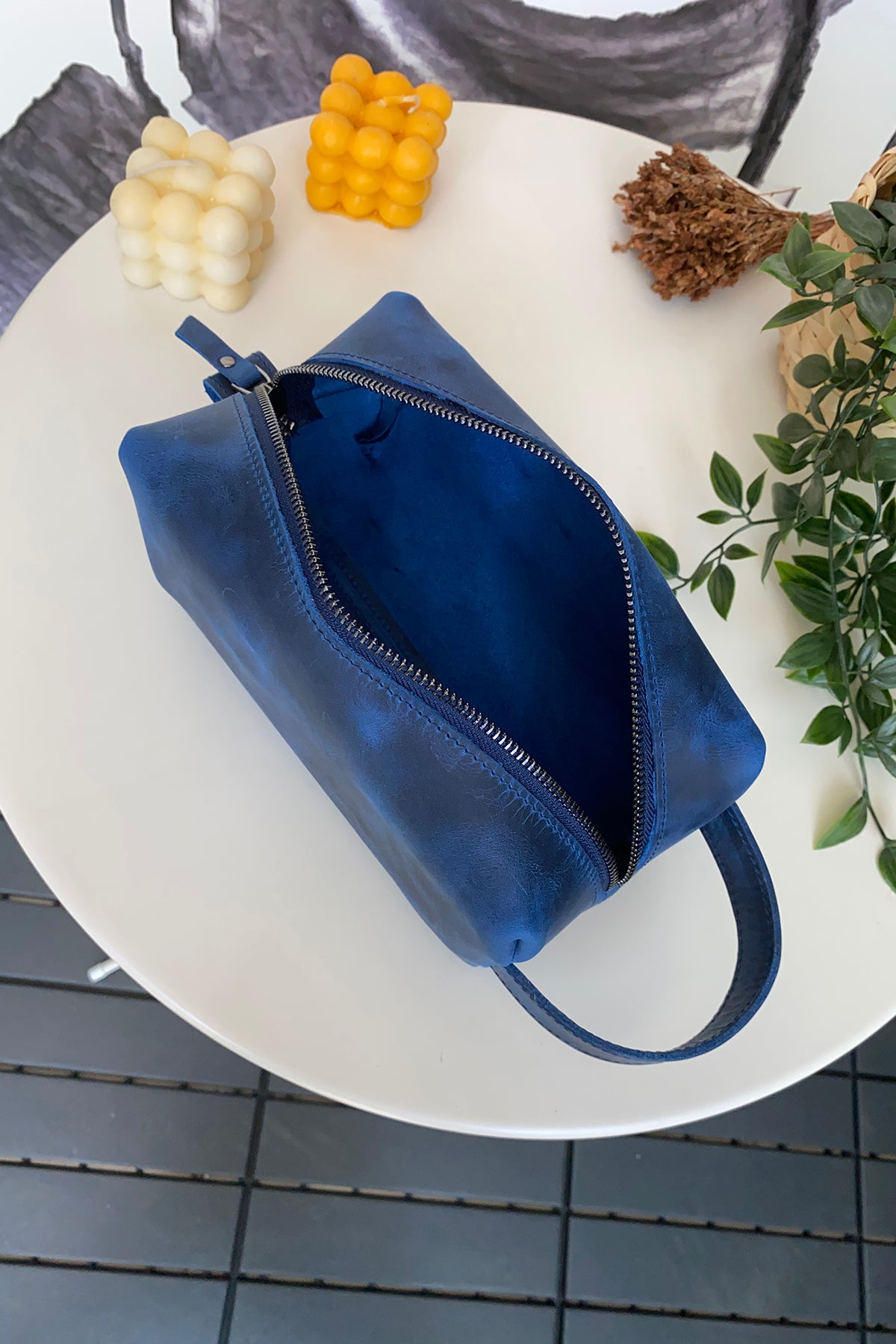 Partenon Genuine Leather Dopp Kit in various colors, showcasing its elegant design and zipper feature.