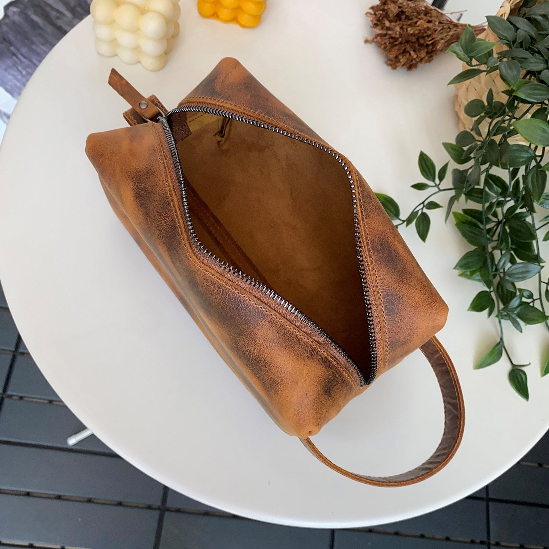 Partenon Genuine Leather Dopp Kit in various colors, showcasing its elegant design and zipper feature.