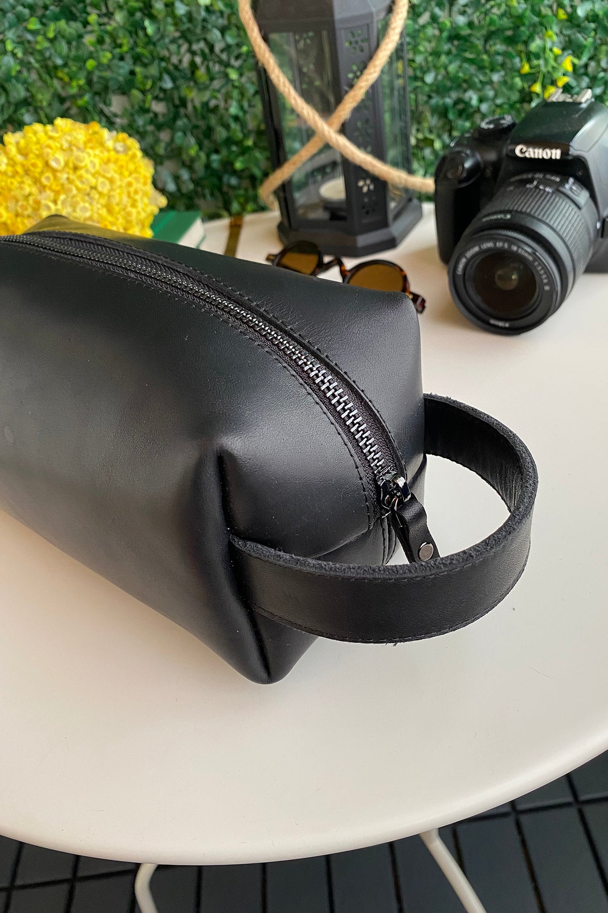 Partenon Genuine Leather Dopp Kit in various colors, showcasing its elegant design and zipper feature.