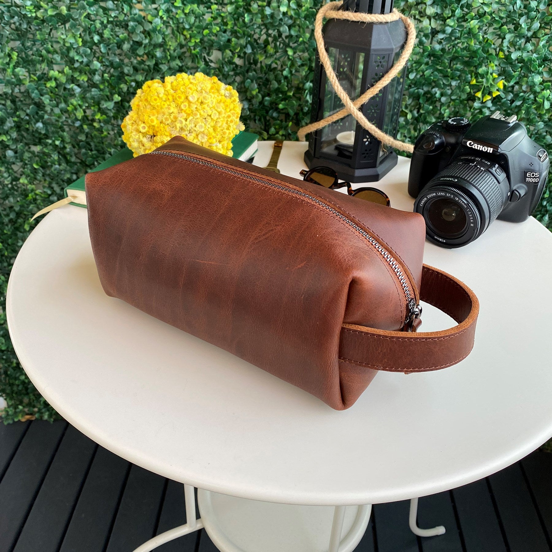 Partenon Genuine Leather Dopp Kit in various colors, showcasing its elegant design and zipper feature.