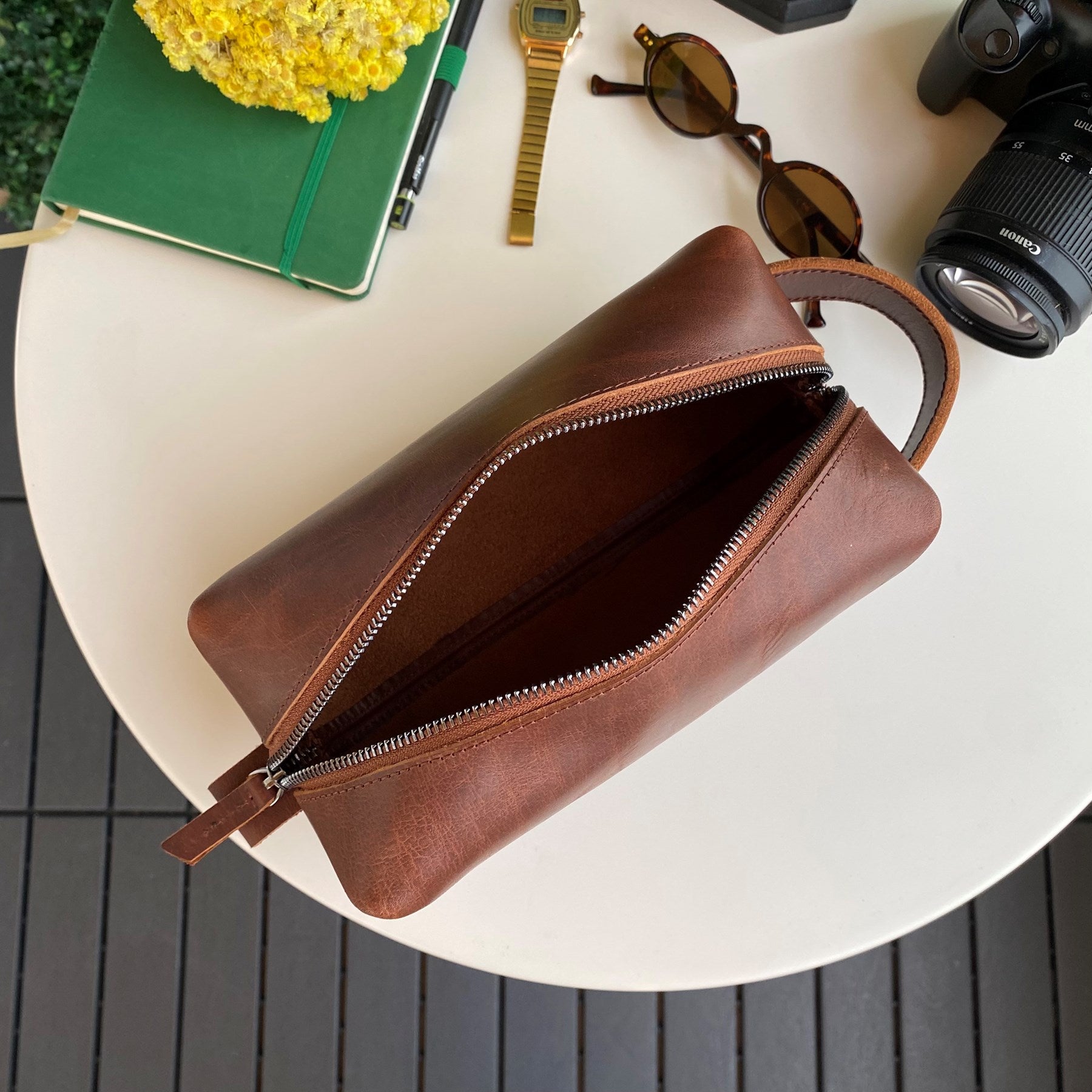 Partenon Genuine Leather Dopp Kit in various colors, showcasing its elegant design and zipper feature.