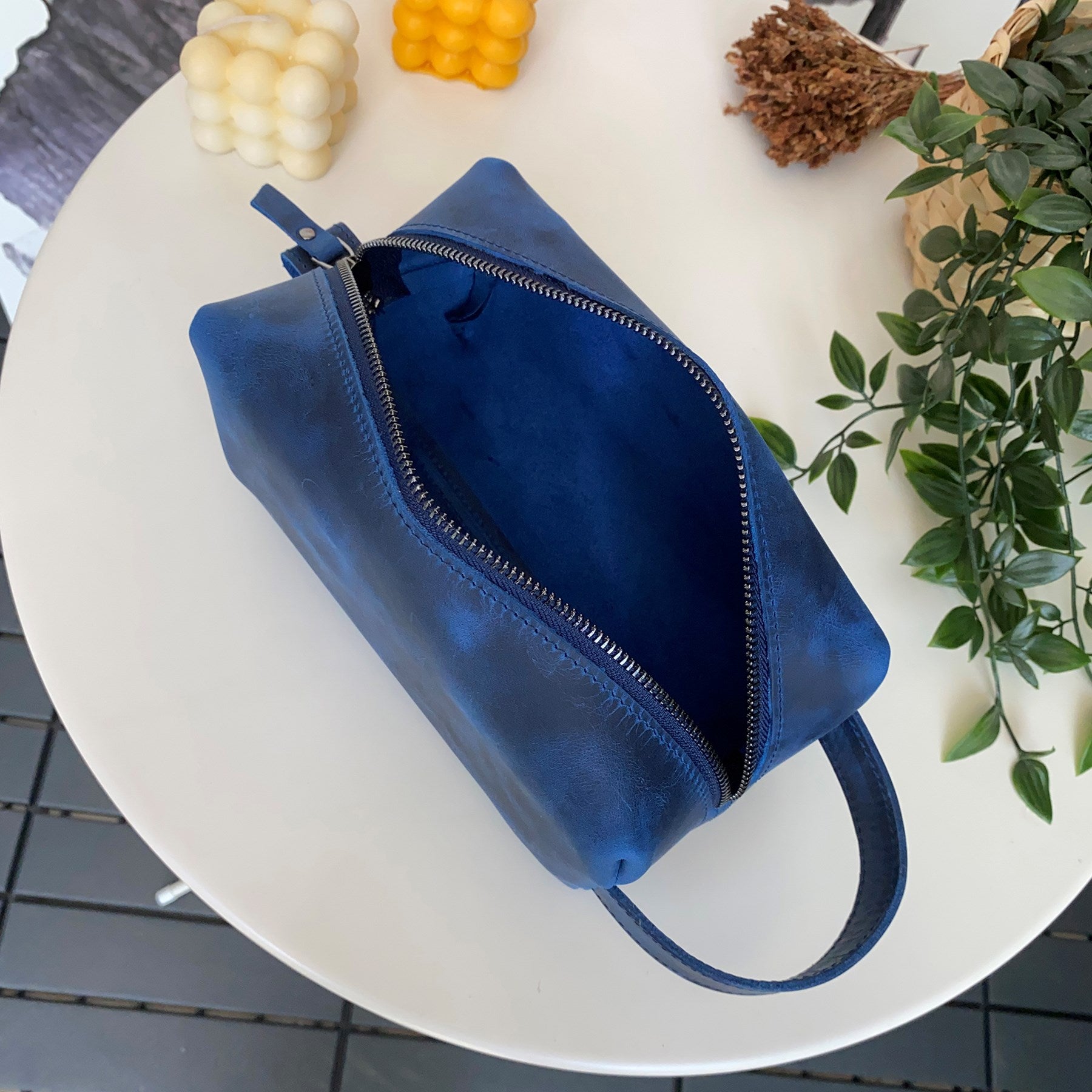 Partenon Genuine Leather Dopp Kit in various colors, showcasing its elegant design and zipper feature.