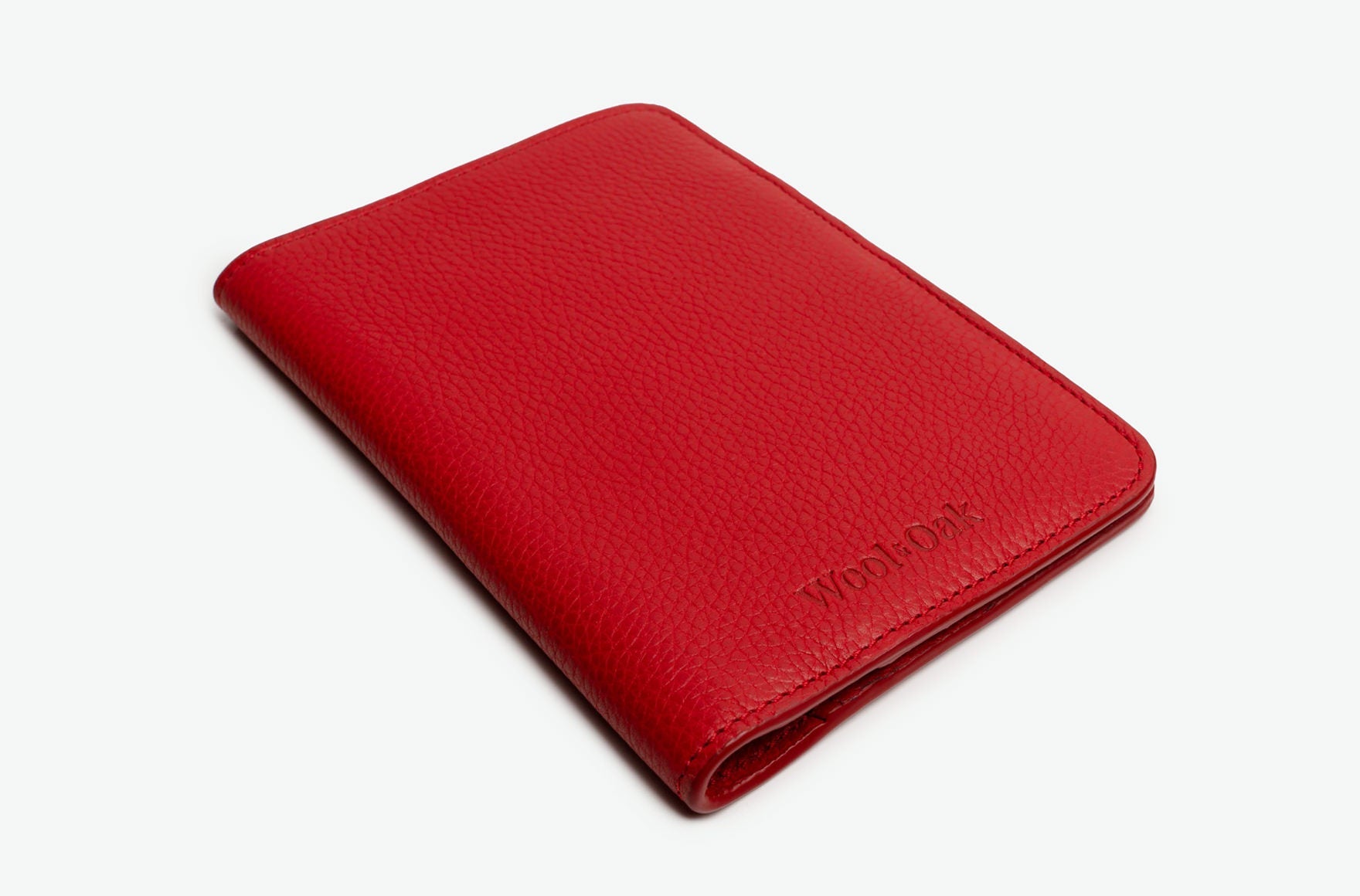 A stylish and functional passport wallet designed for travelers, featuring multiple slots for passports and cards, made from durable material.