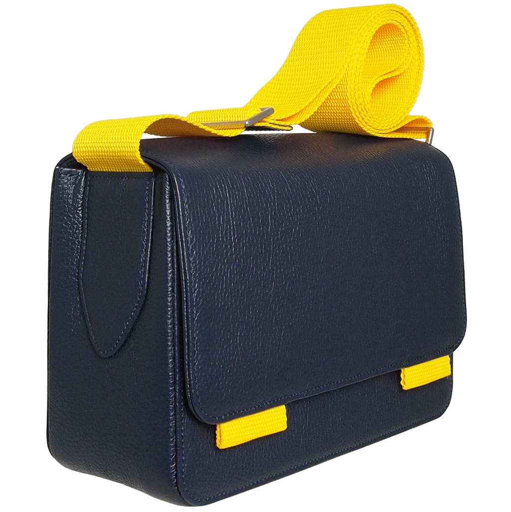 A stylish blue pebbled leather crossbody bag with a magnetic flap closure and a contrasting wide vinyl strap, showcasing its elegant design and craftsmanship.