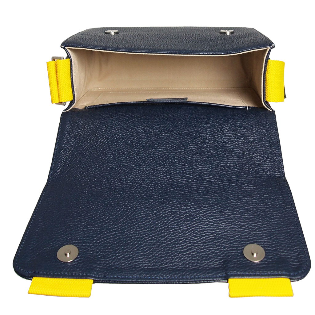 A stylish blue pebbled leather crossbody bag with a magnetic flap closure and a contrasting wide vinyl strap, showcasing its elegant design and craftsmanship.