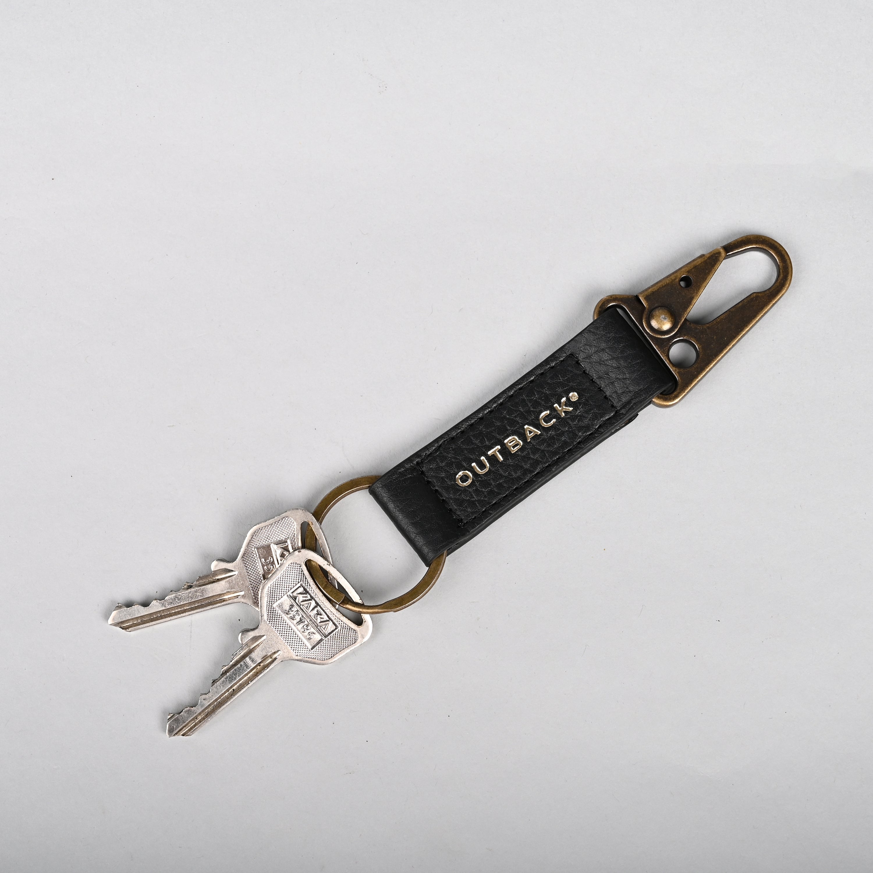 Performance Key Holder made from premium leather with antique brass hardware, showcasing its elegant design and craftsmanship.