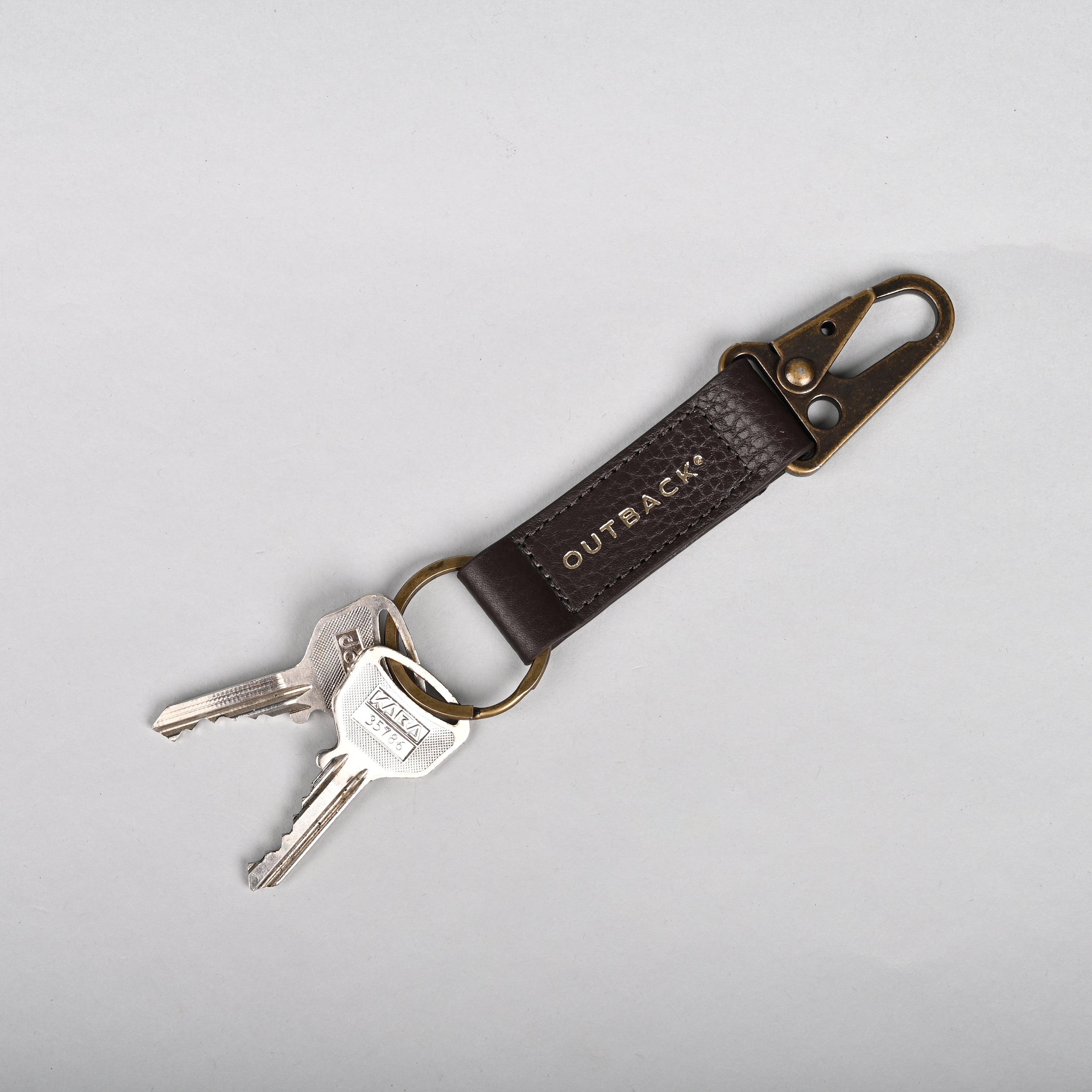 Performance Key Holder made from premium leather with antique brass hardware, featuring a snap hook mechanism.