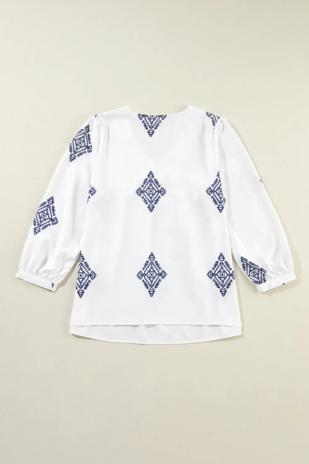 A stylish Printed V-Neck Three-Quarter Sleeve Blouse featuring a modern print, perfect for casual or dressy occasions.