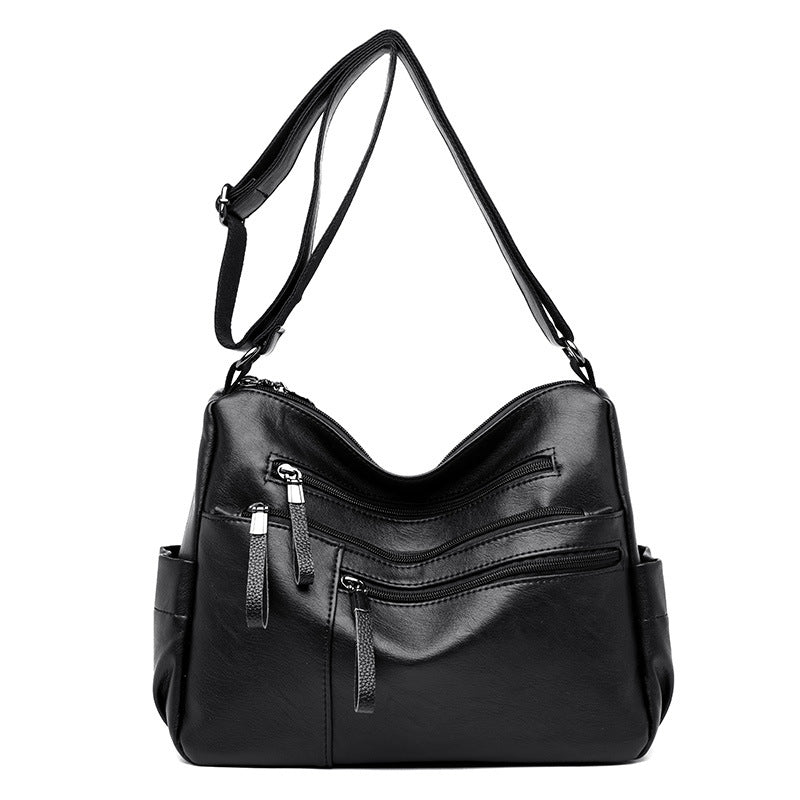 A stylish PU leather women's messenger bag in a horizontal square shape, featuring a zipper opening and a soft polyester cotton lining.