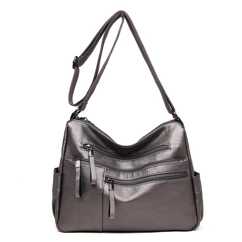 A stylish PU leather women's messenger bag in a horizontal square shape, featuring a zipper opening and a soft polyester cotton lining.